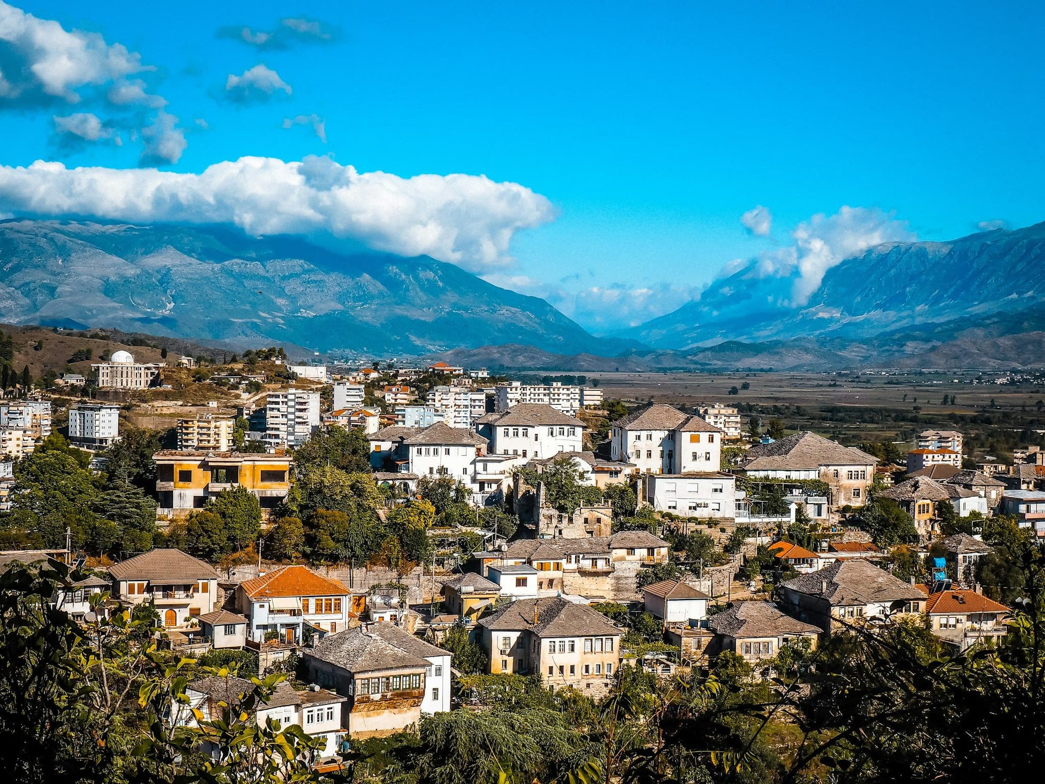 Stone houses of Gjirokastër with mountains behind