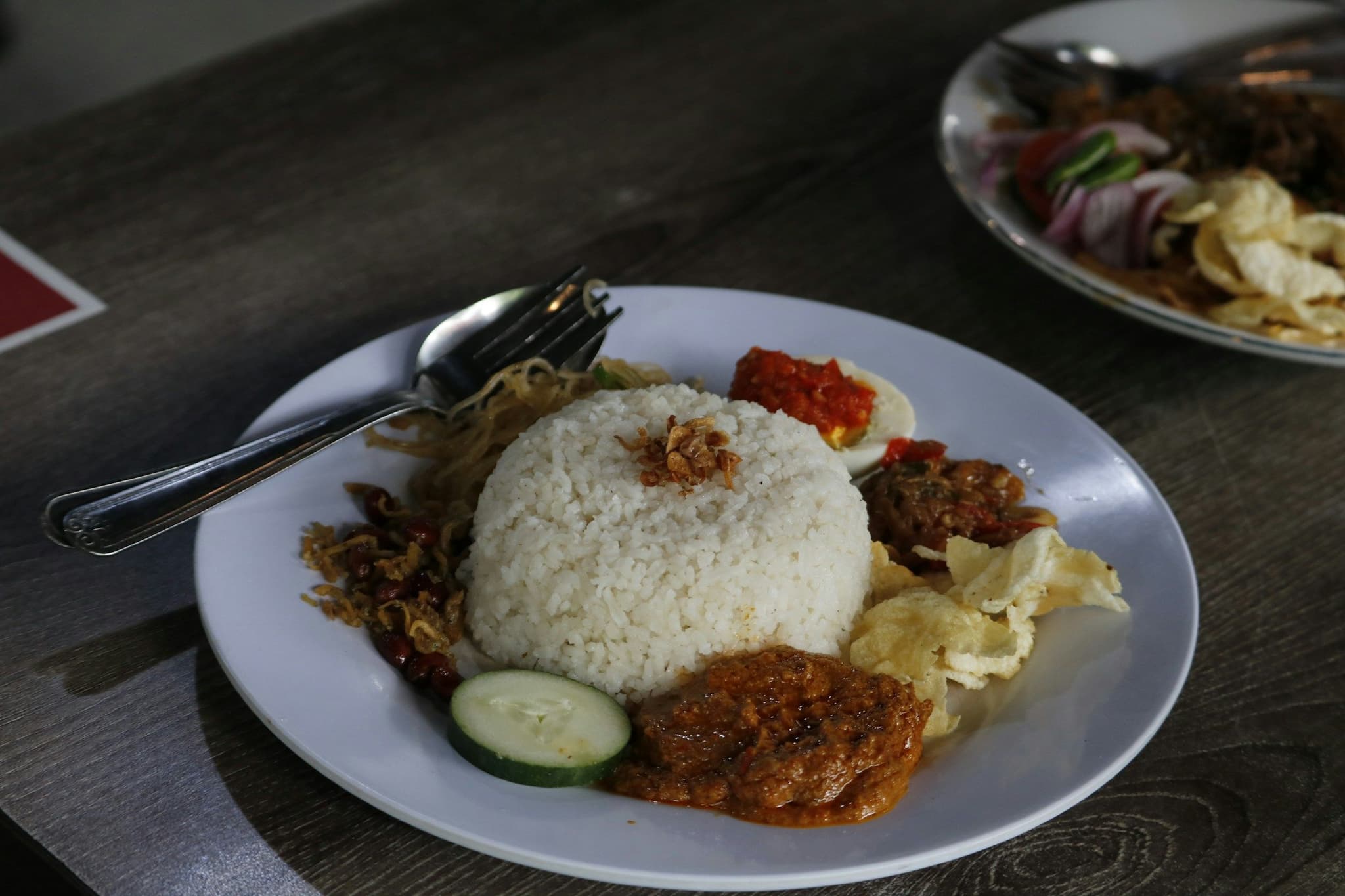 A plate of nasi lemak with sambal and sides