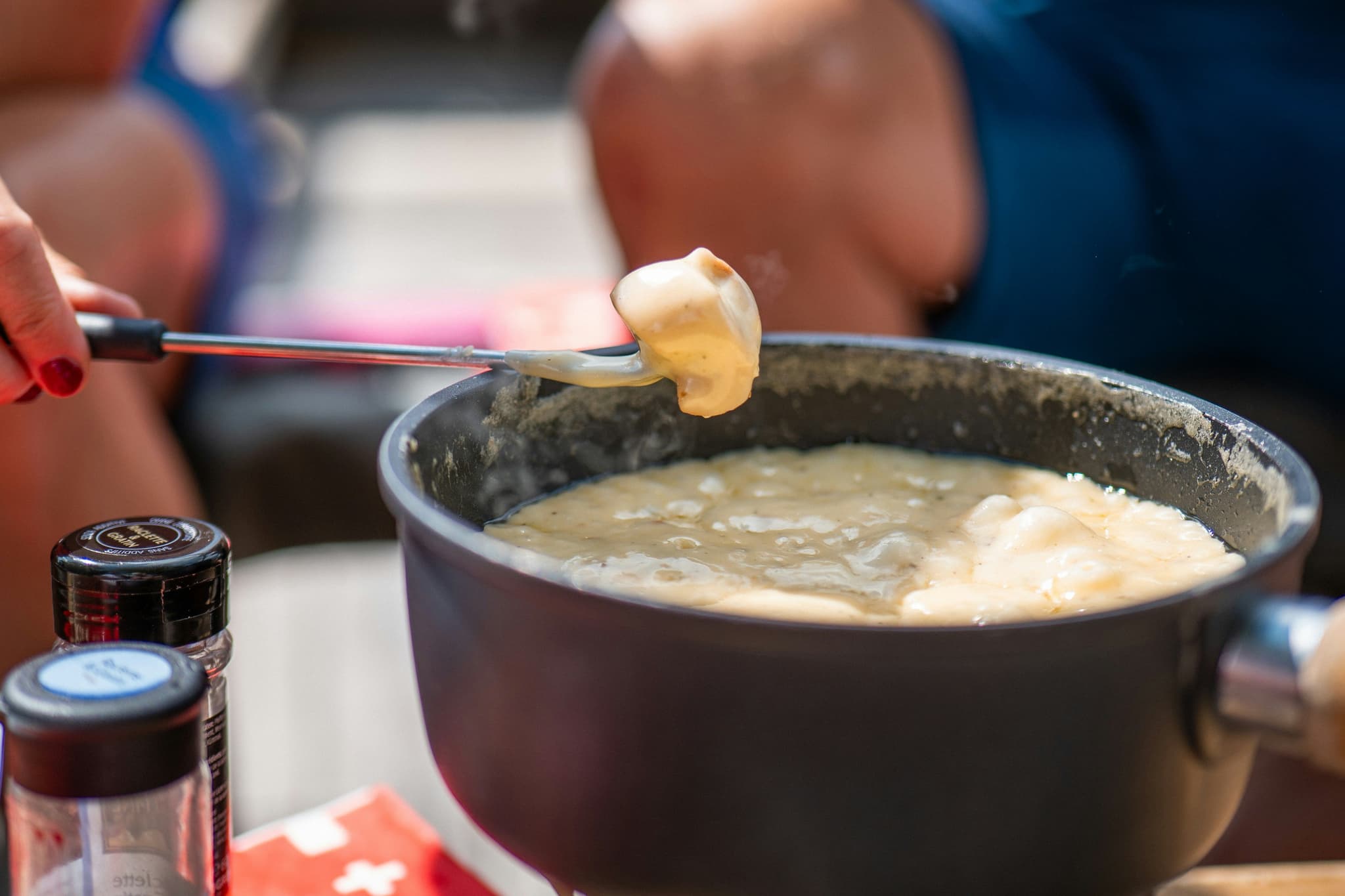 Cheese fondue pot with bread cubes ready for dipping