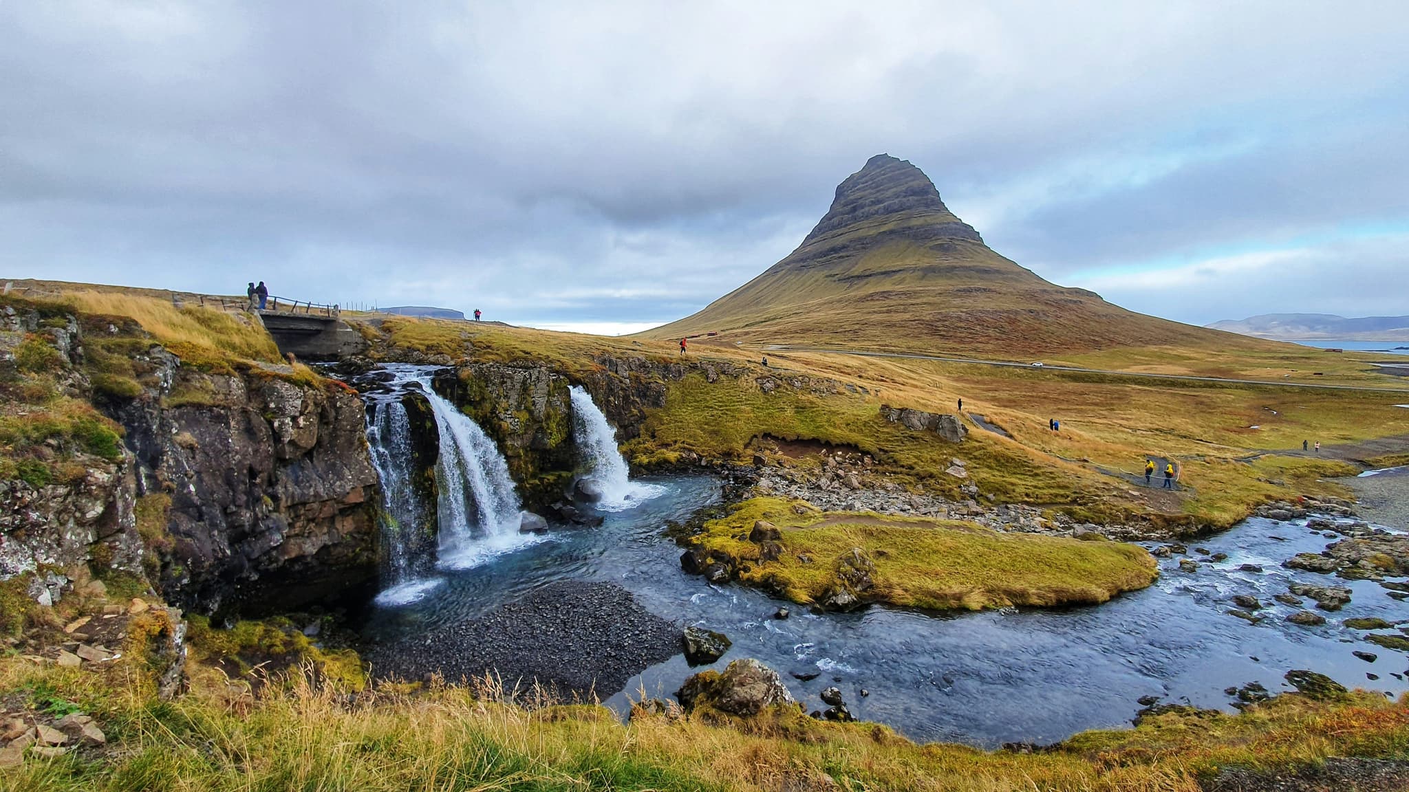 Kirkjufell mountain with waterfall and green grass