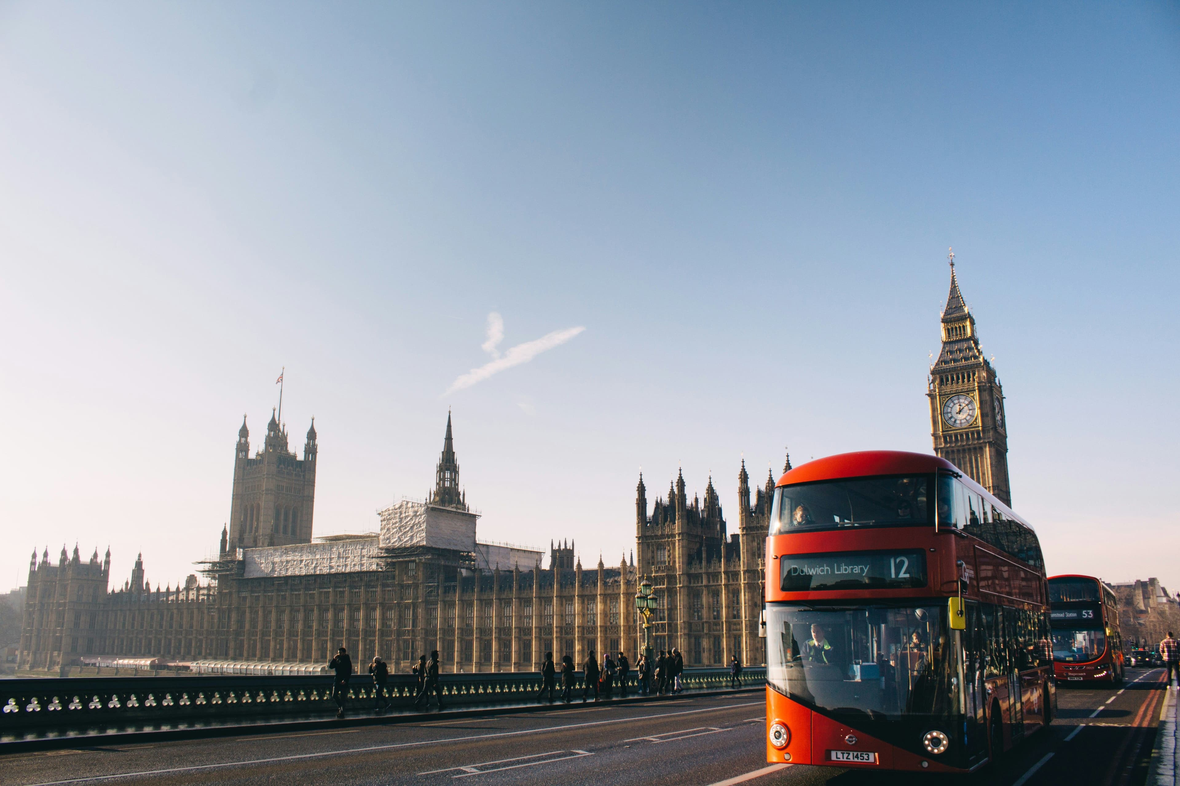 City view of UK with a red bus on the road