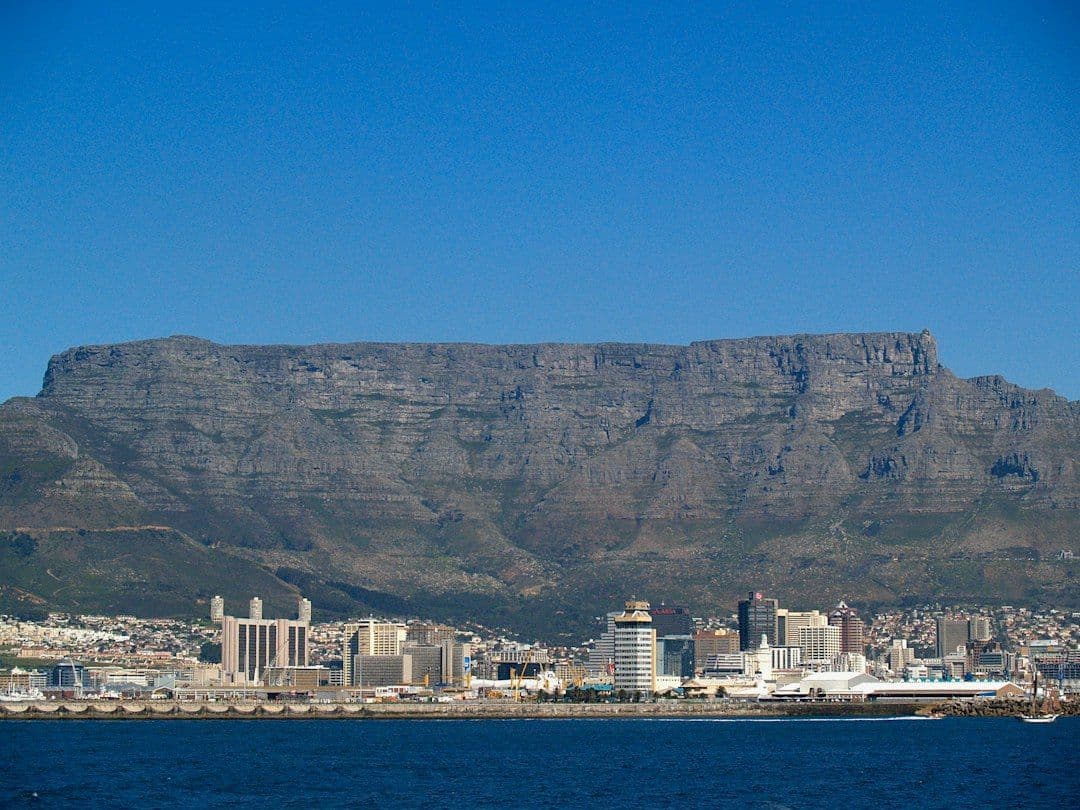 Cape Town's waterfront with Table Mountain rising behind it, seen from the sea.