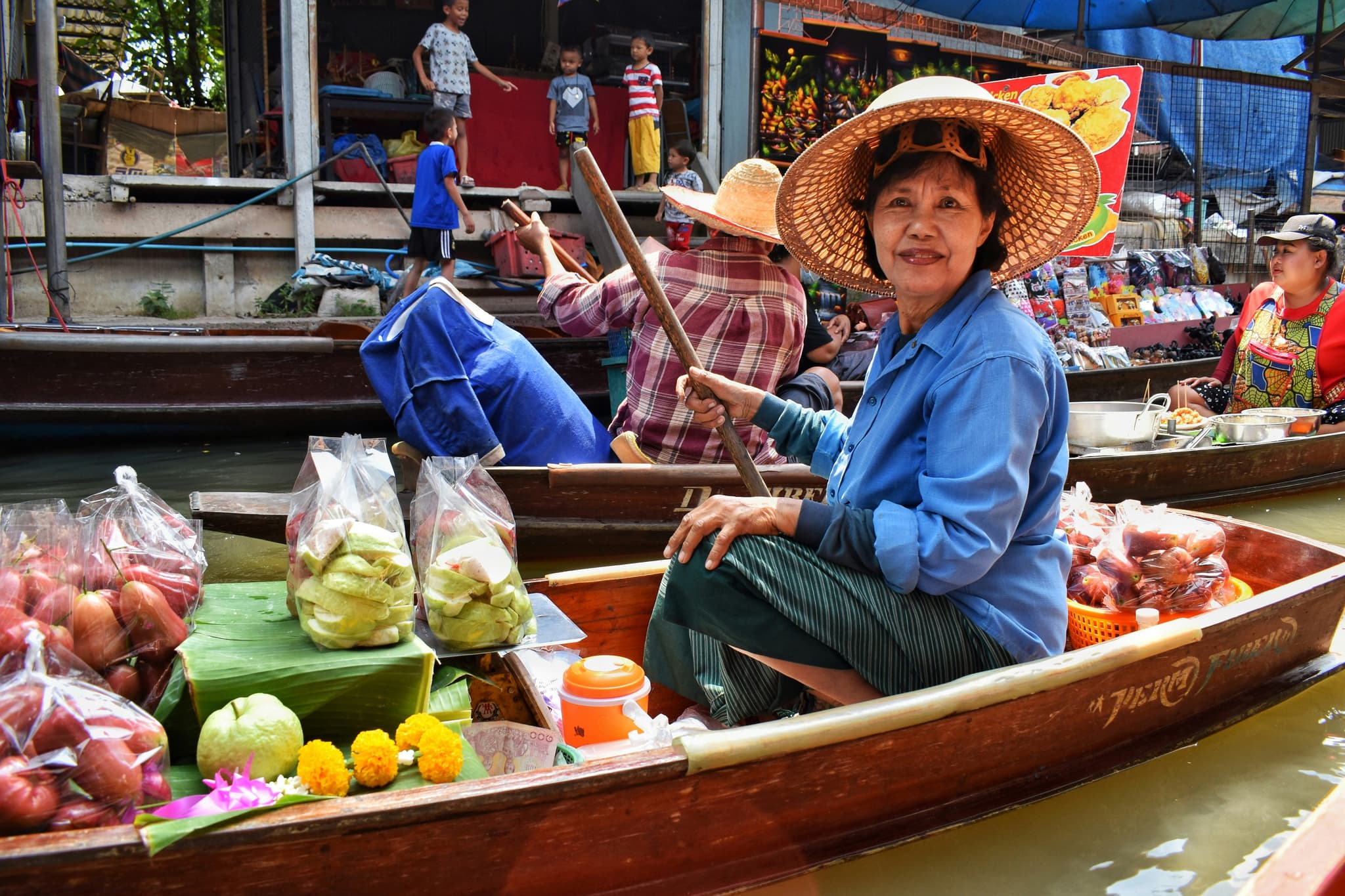 Vietnamese woman on a boat in a floating market in vietnam