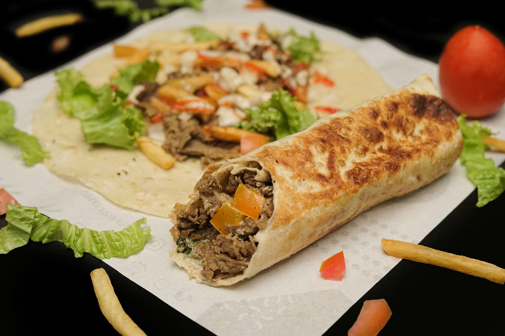 Wrapped shawarma and open shawarma with meat and lettuce and tomato