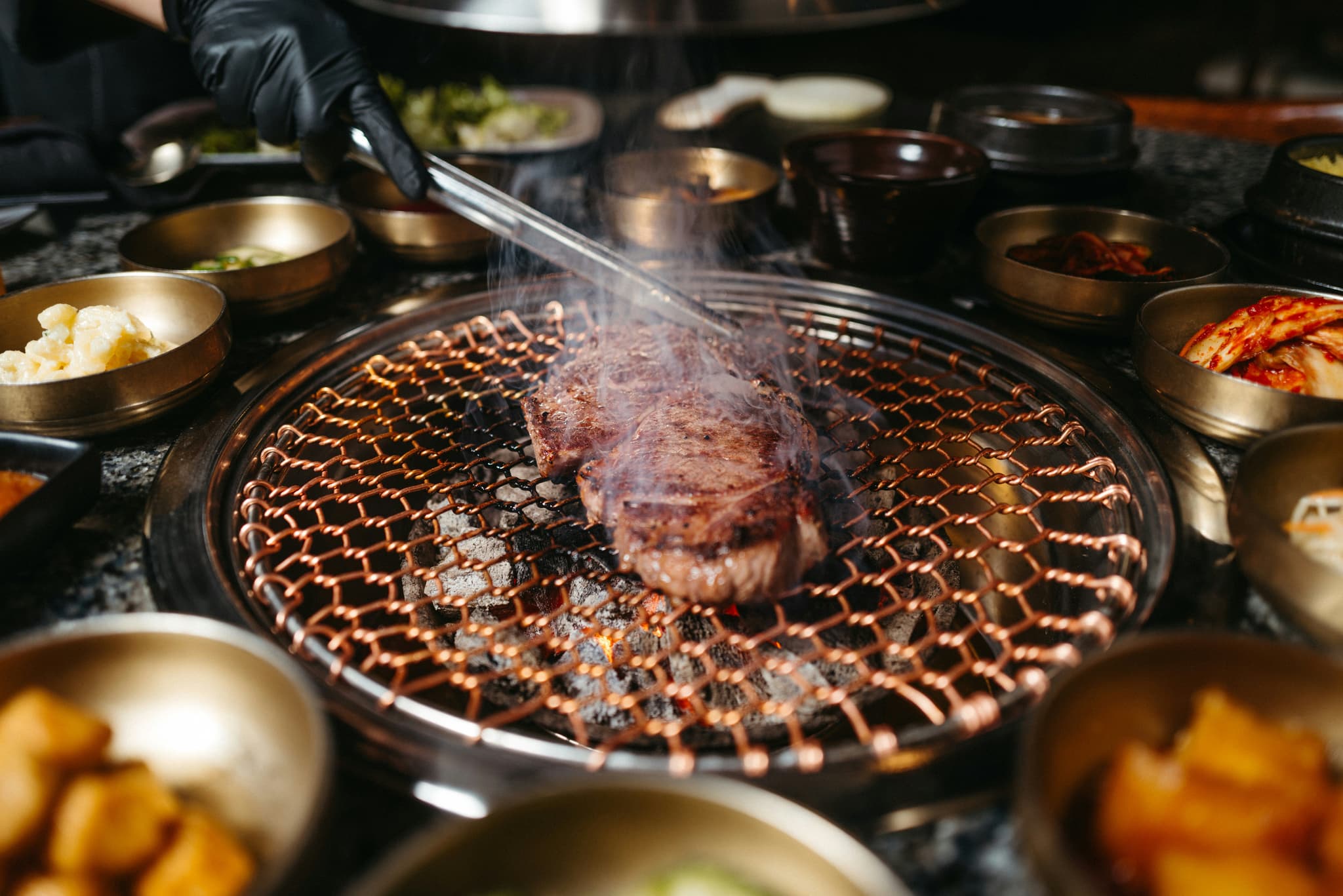 Samgyeopsal pork belly grilling on Korean BBQ table