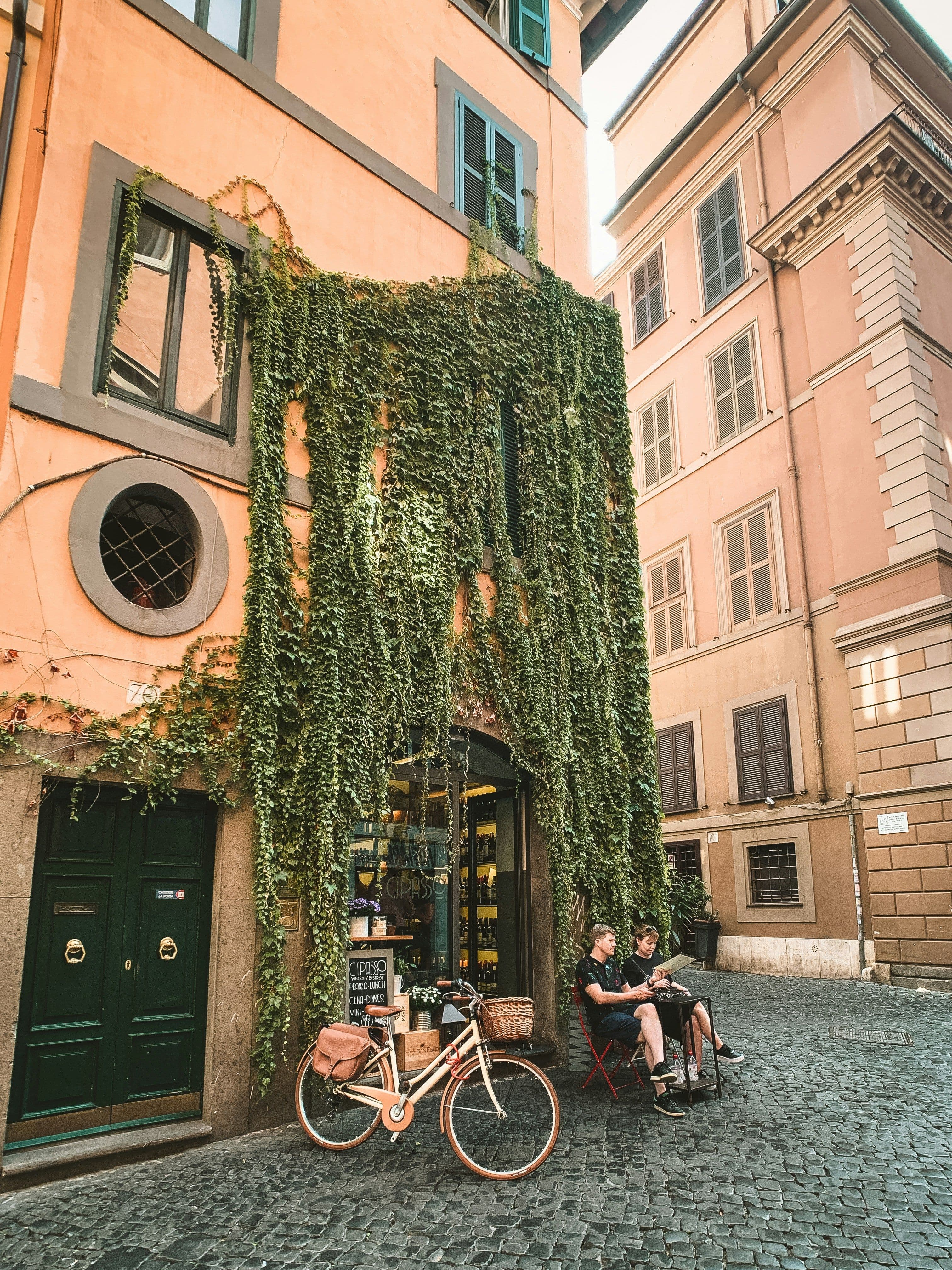 2 people sitting in a Rome street