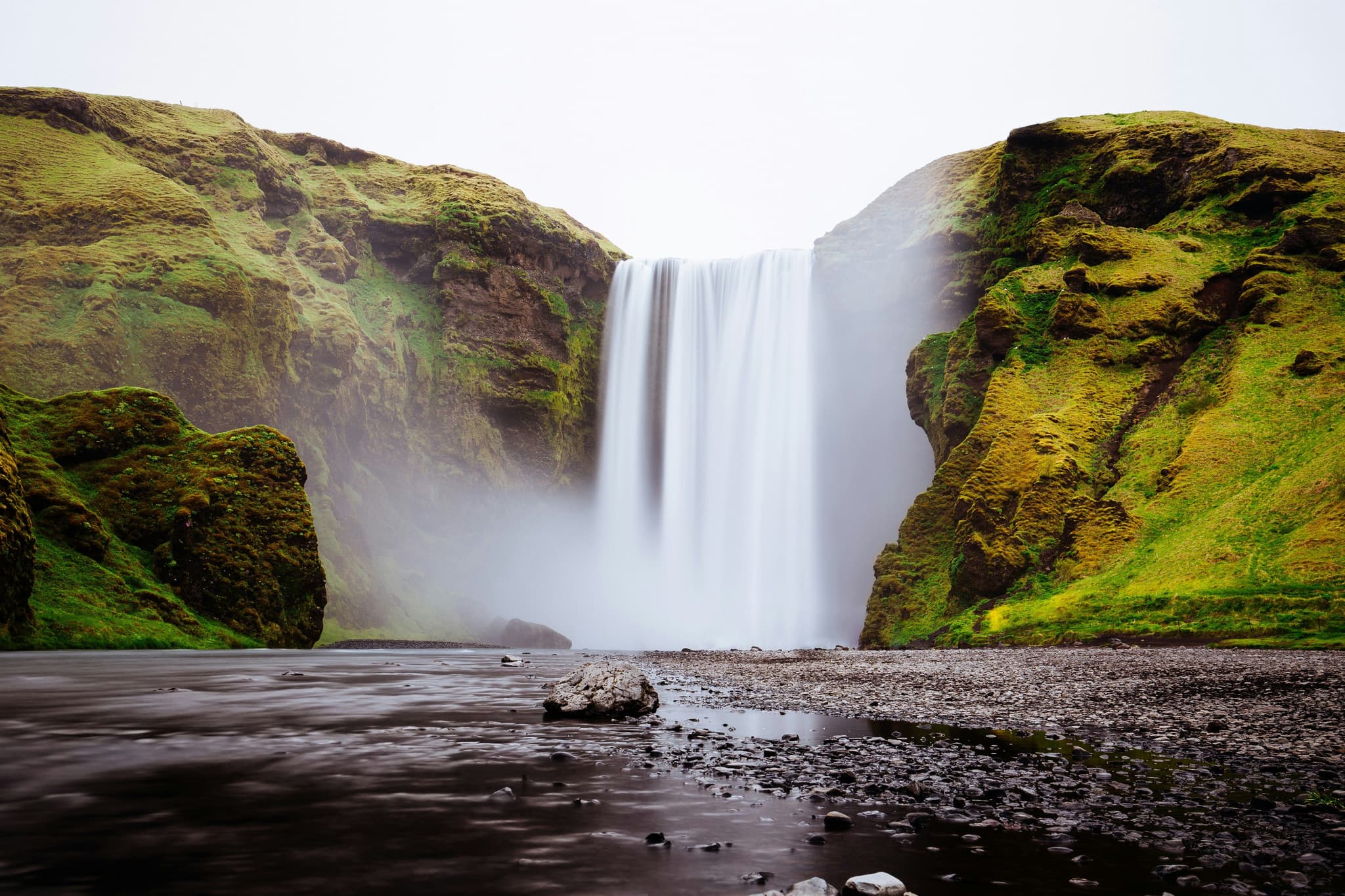 Skógafoss waterfall surrounded by green nature