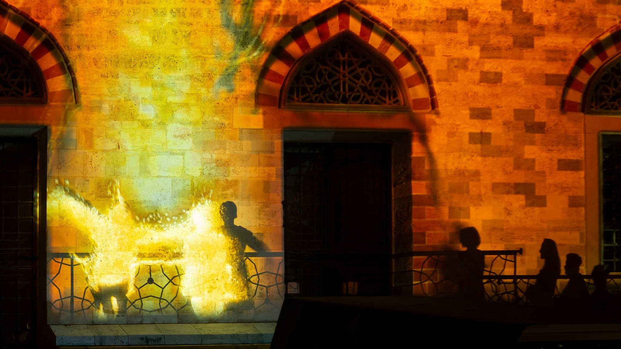 Light projections on a historic building in Pécs at night