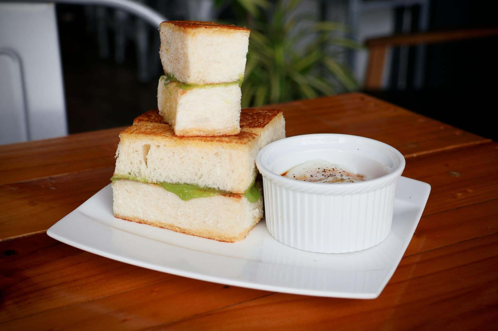 Kaya toast with half-boiled eggs and a cup of coffee