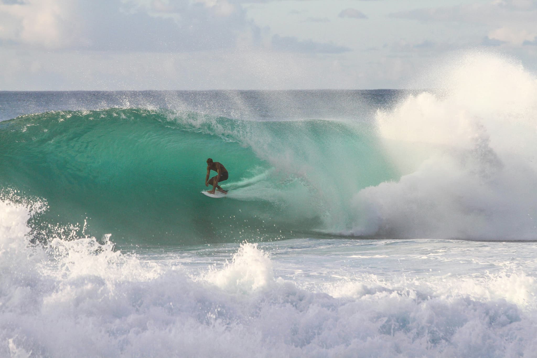 surfer riding wave in sea water in philippines