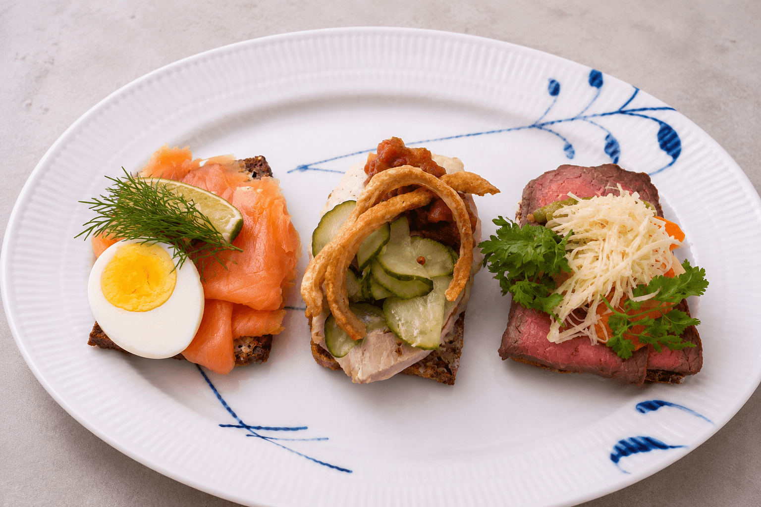 Three smorrebrod with salmon, egg, dille, and meat