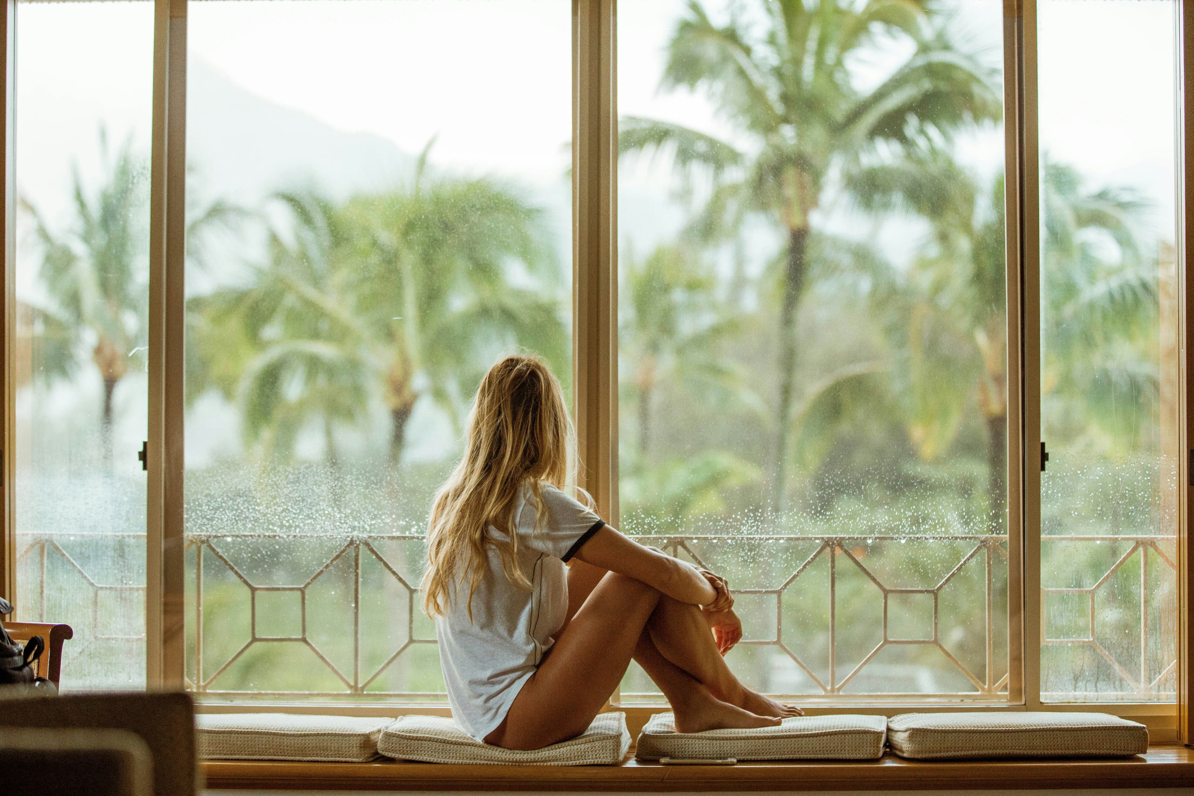 girl looking out of window in luxury hotel