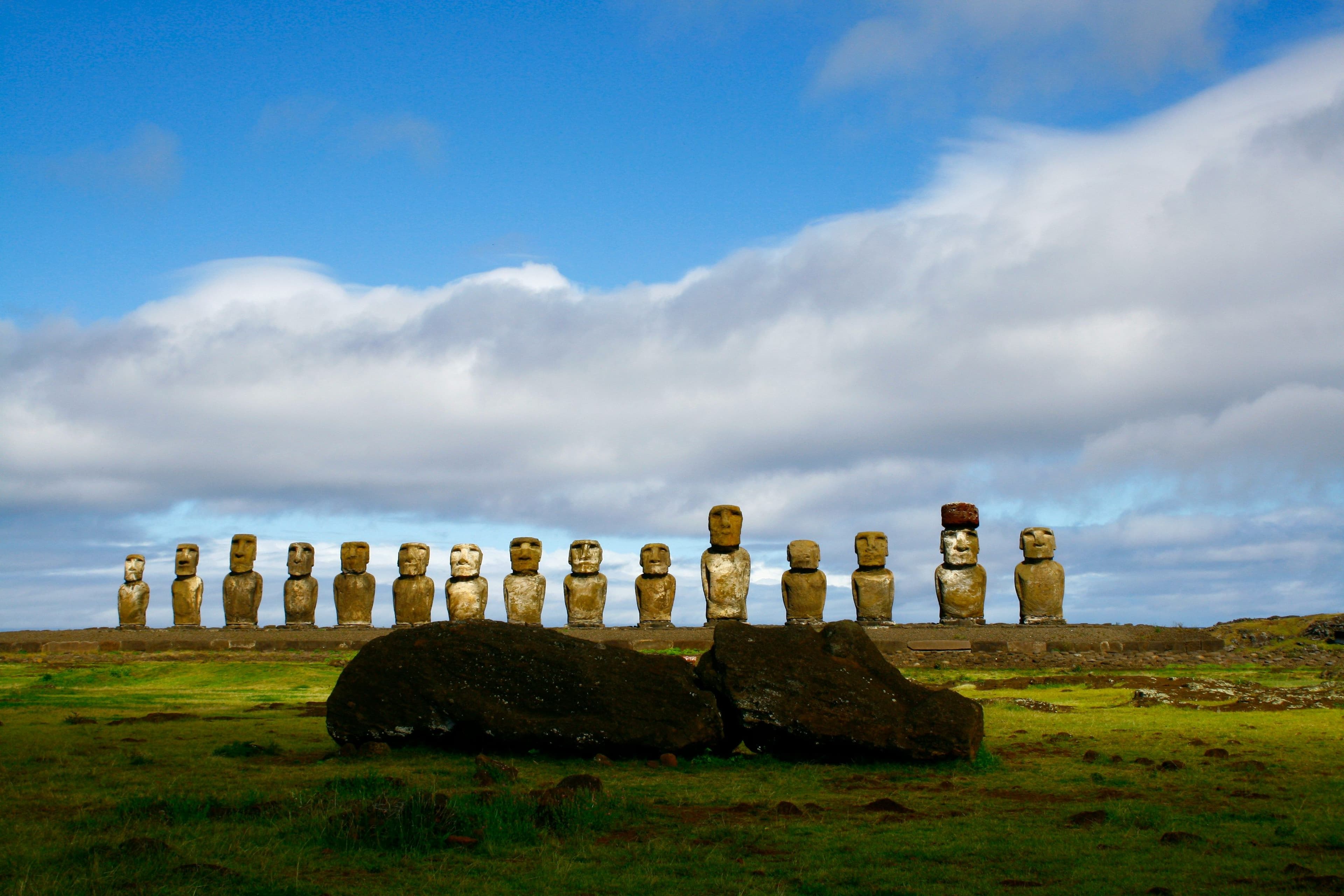 Stone face sculptures on grass in Easter Island Chile
