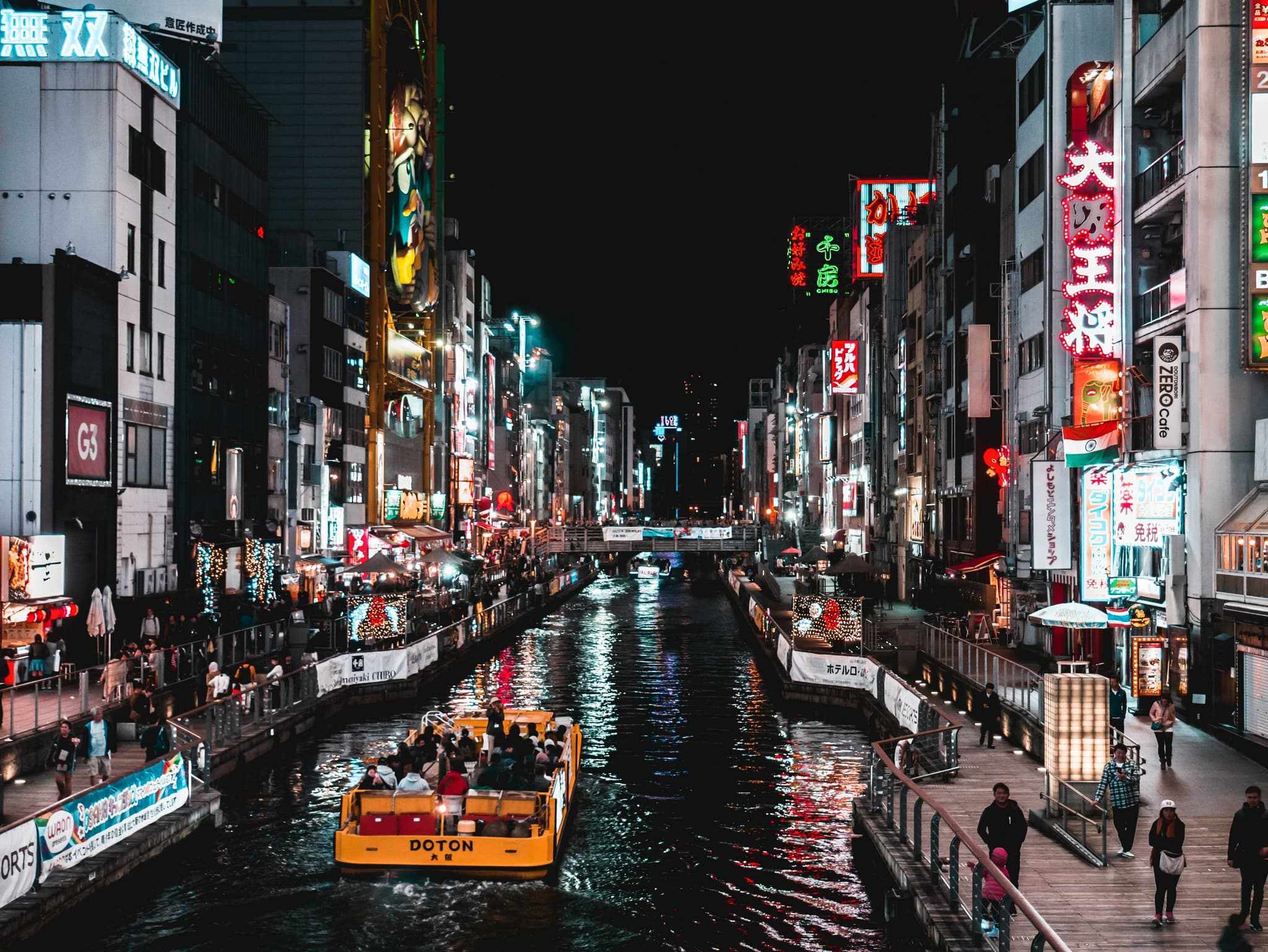 Neon signs and canal boats in Osaka's Dotonbori district at night