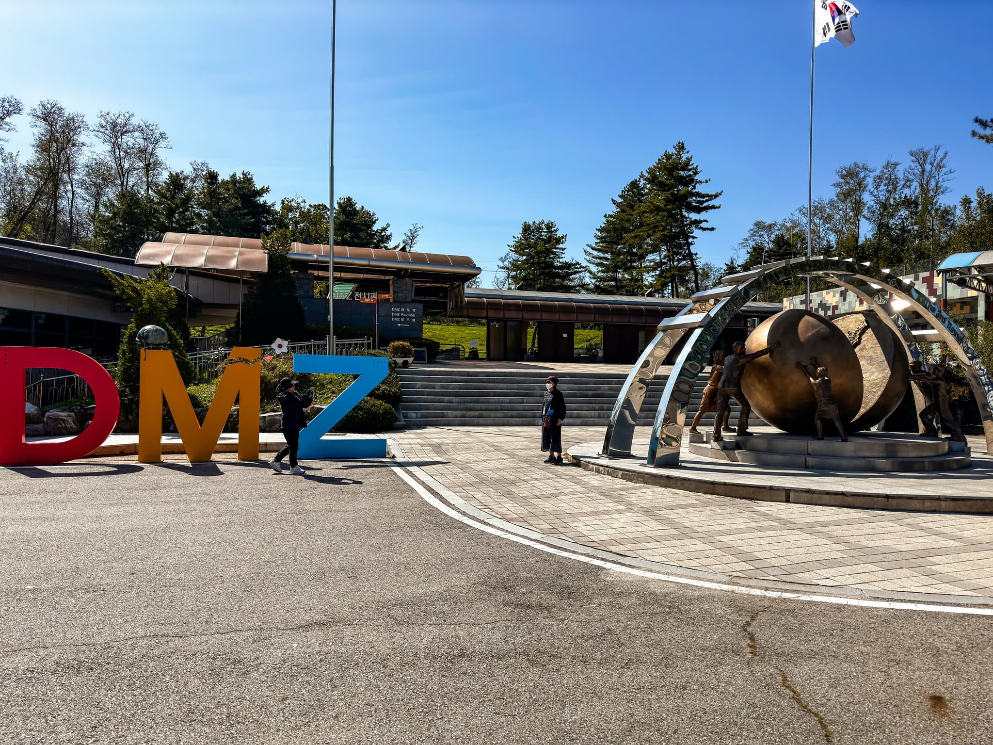 A colourful sign of the letters DMZ on a street in Korea