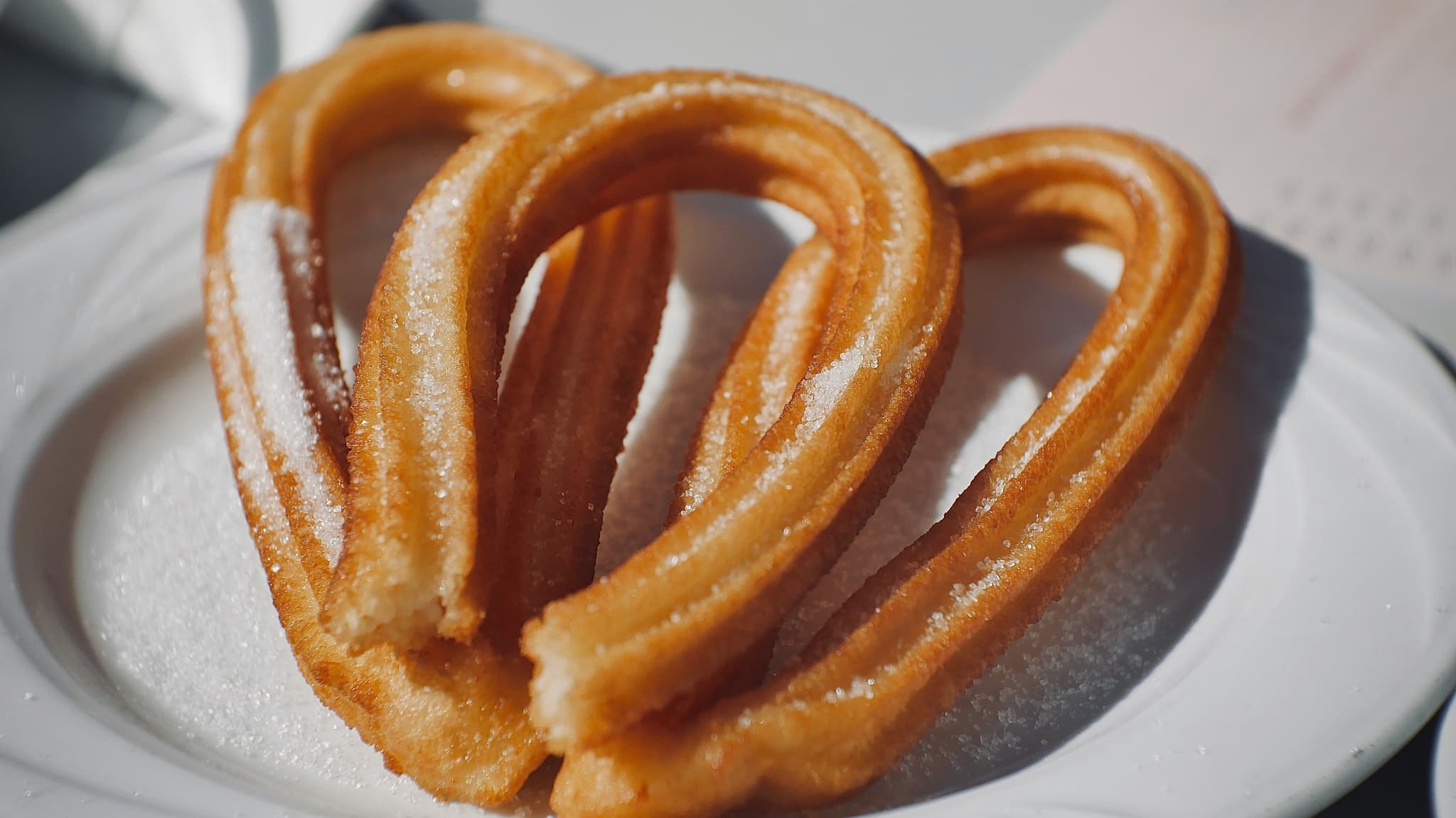 Two churros on a white plate