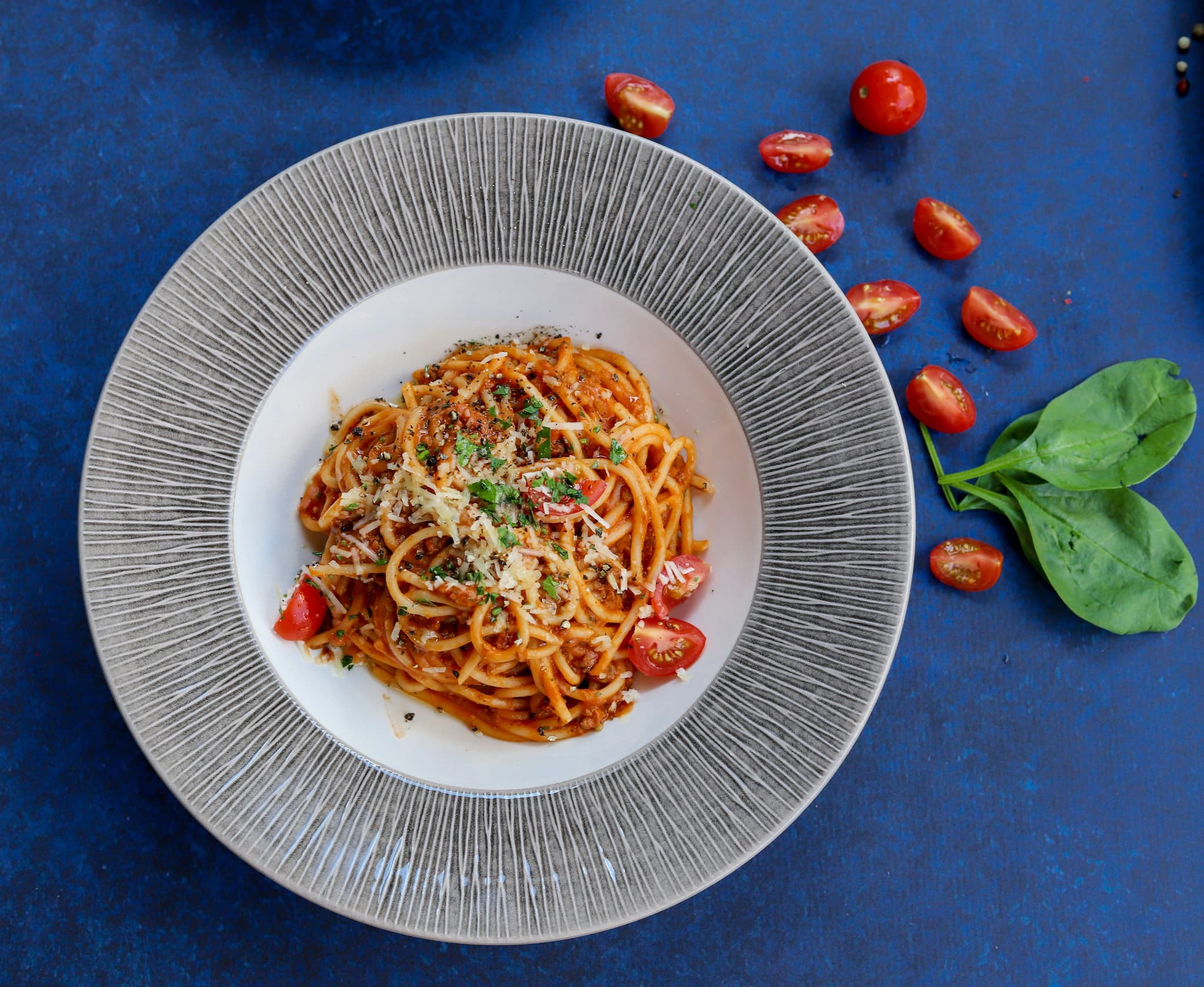 Spaghetti bolognese on a grey plate