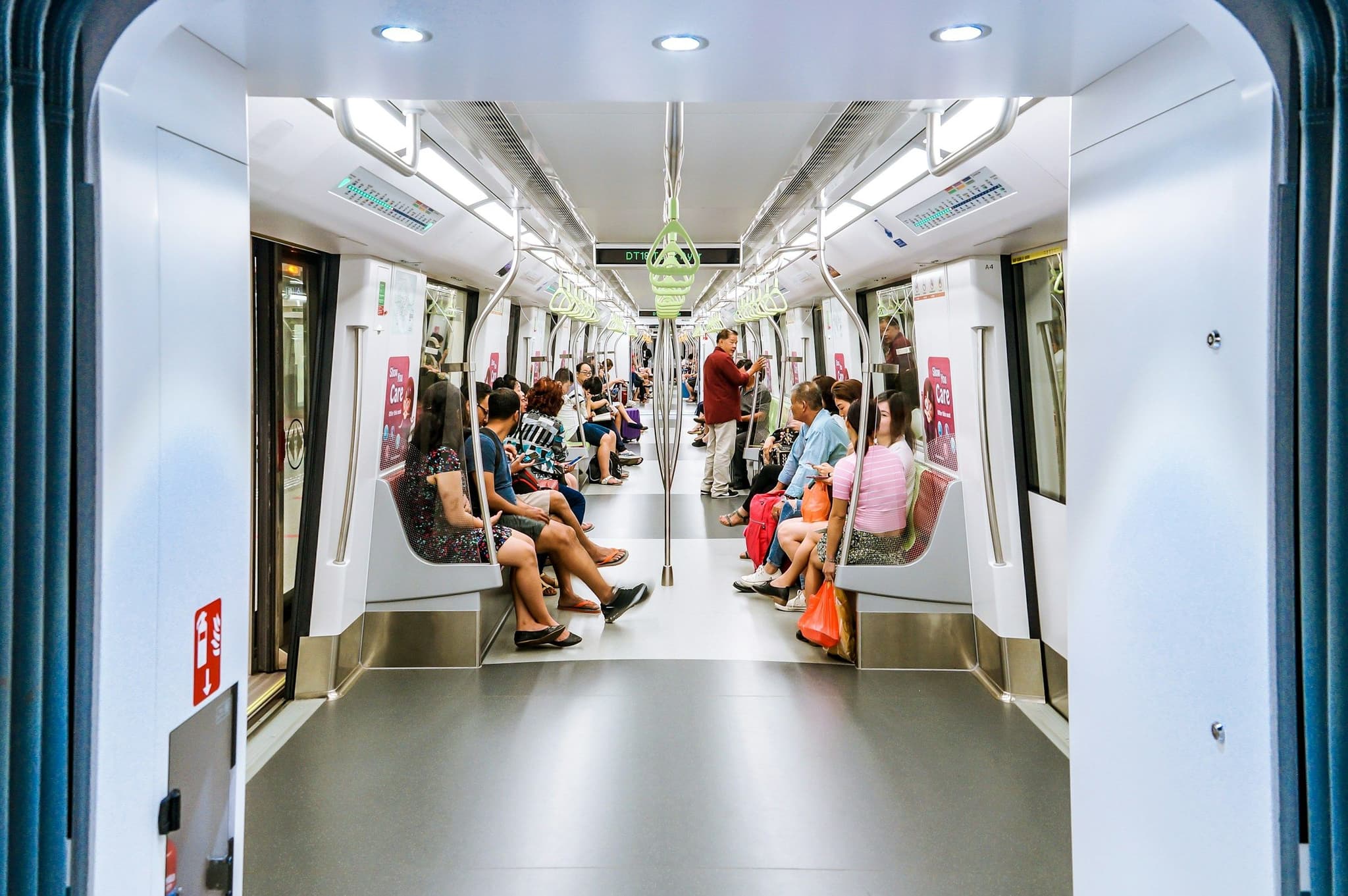 Passengers seated on a Singapore MRT train