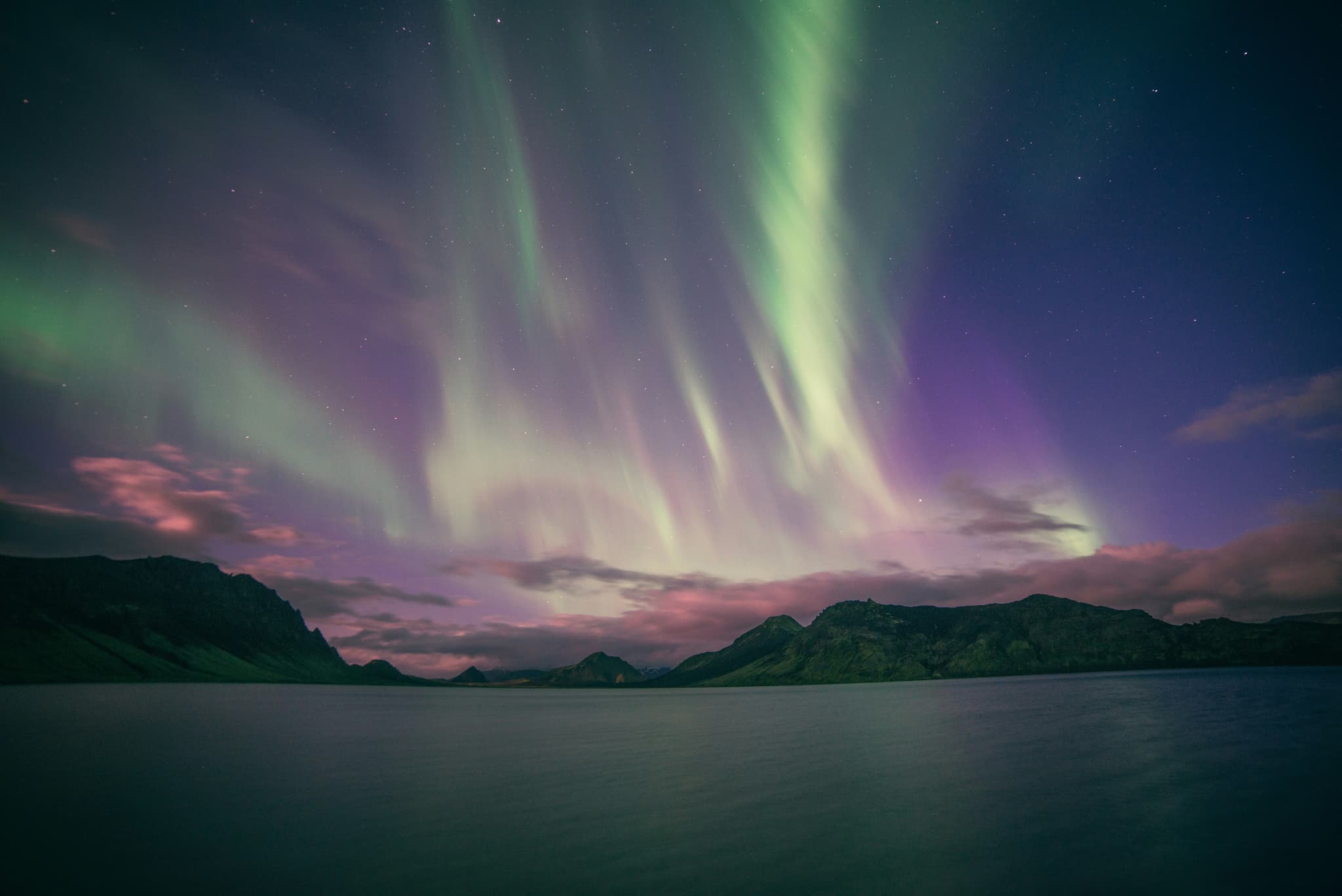 Green Northern Lights glowing over an Icelandic landscape in winter