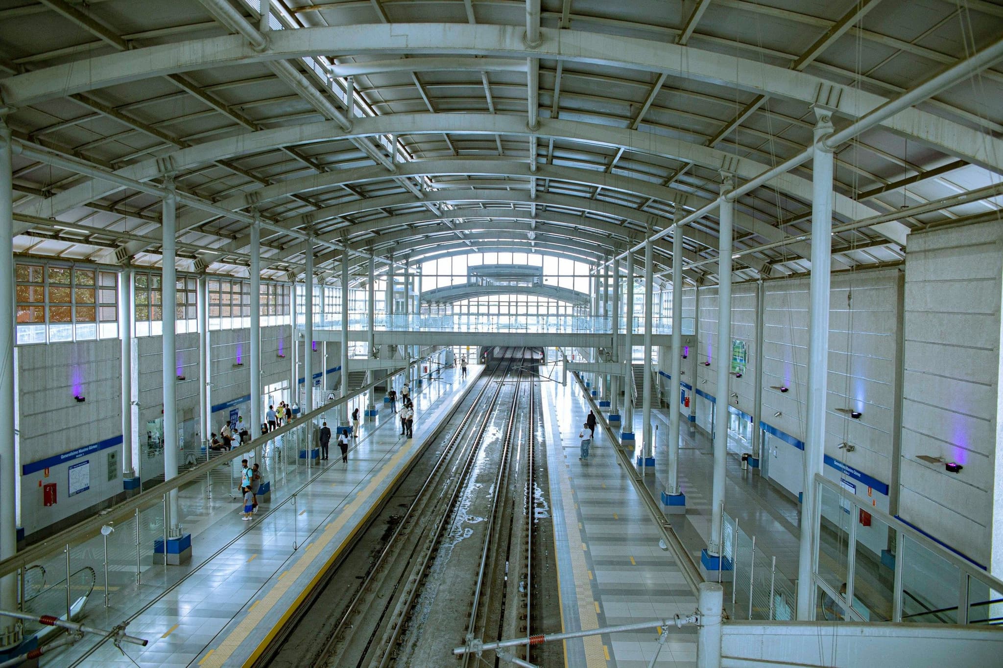 Passengers walking along a metro platform