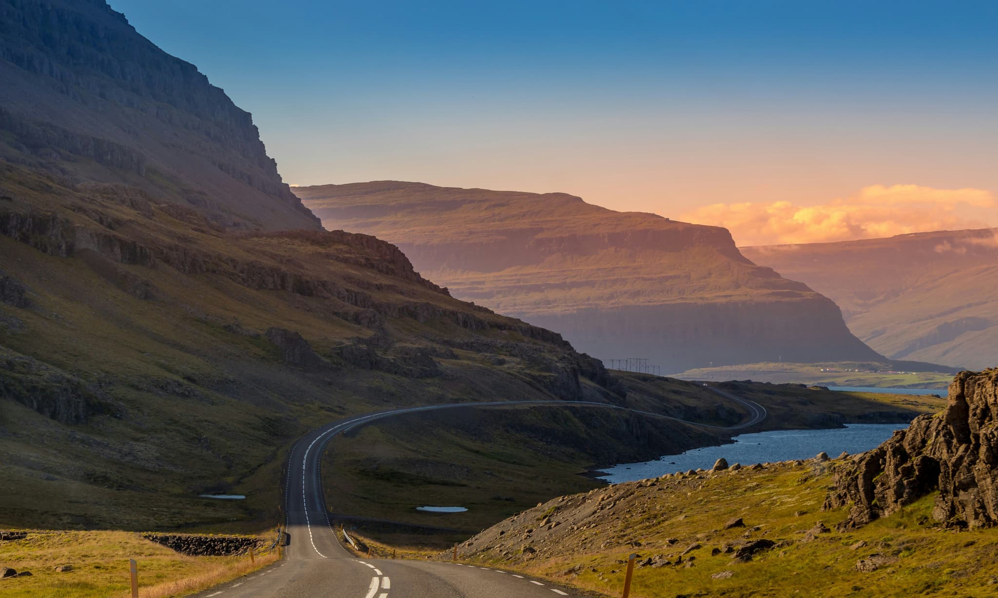 Ring road in iceland surrounded by mountains during sunset