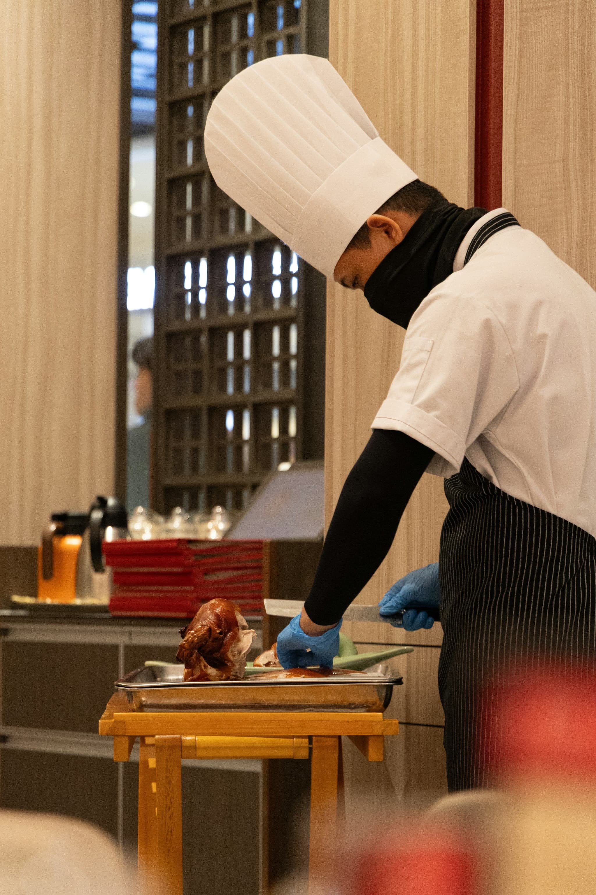 A chef carving a roast duck