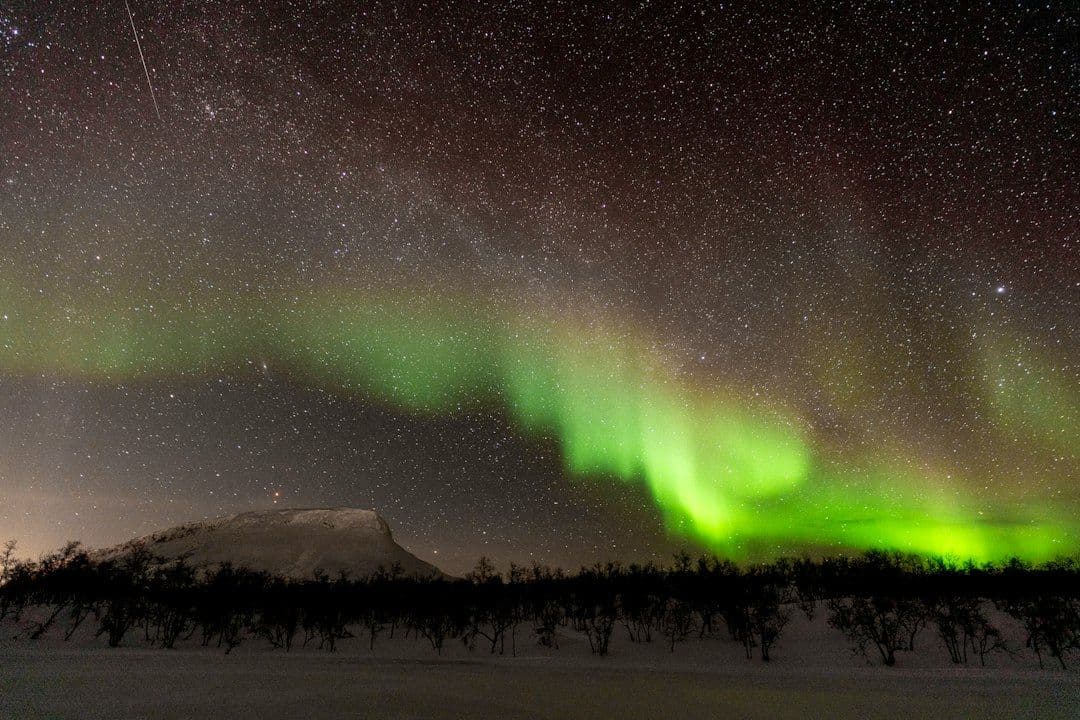 The aurora borealis in green and purple over Saana fell near Kilpisjärvi in Finnish Lapland.