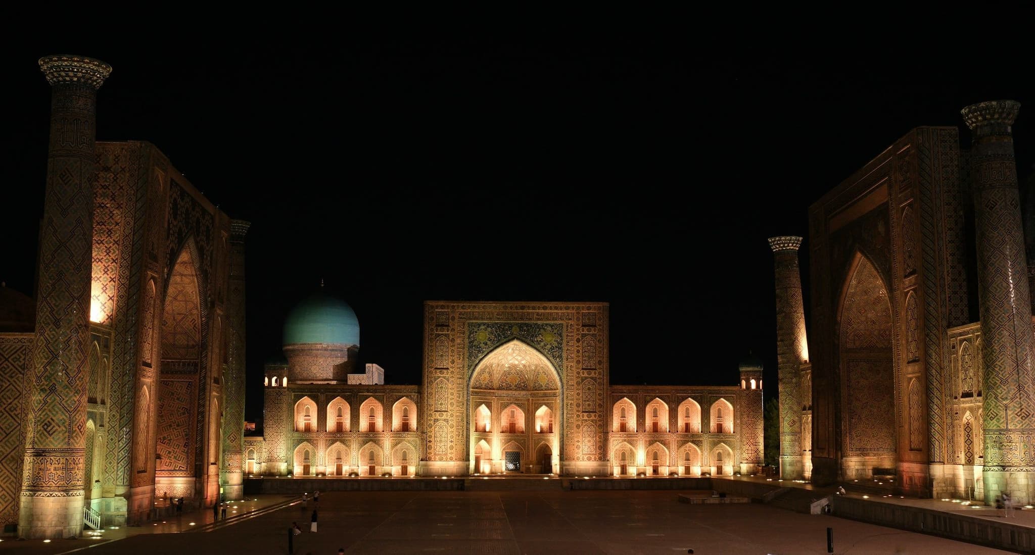 The Registan madrasas lit up at night in Samarkand
