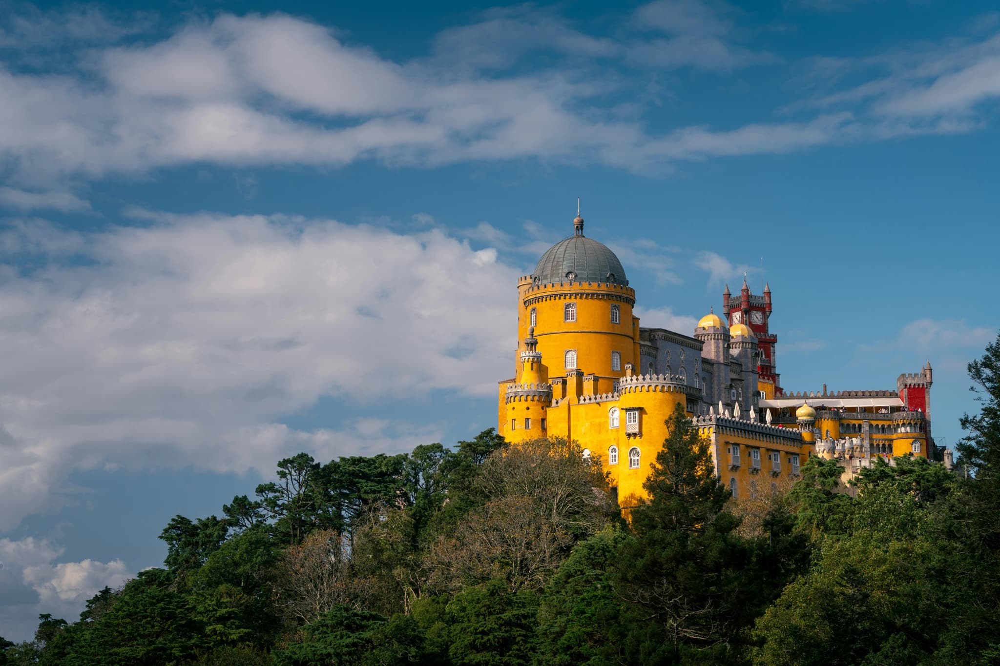 Colourful Pena Palace rising above the forested hills of Sintra, Portugal