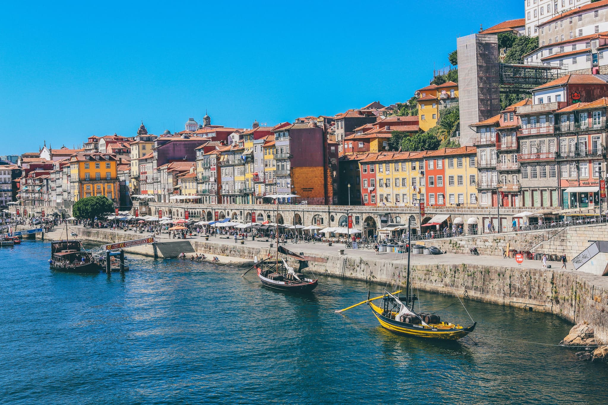Harbor and boats on the river of a city with colourful houses in Portugal