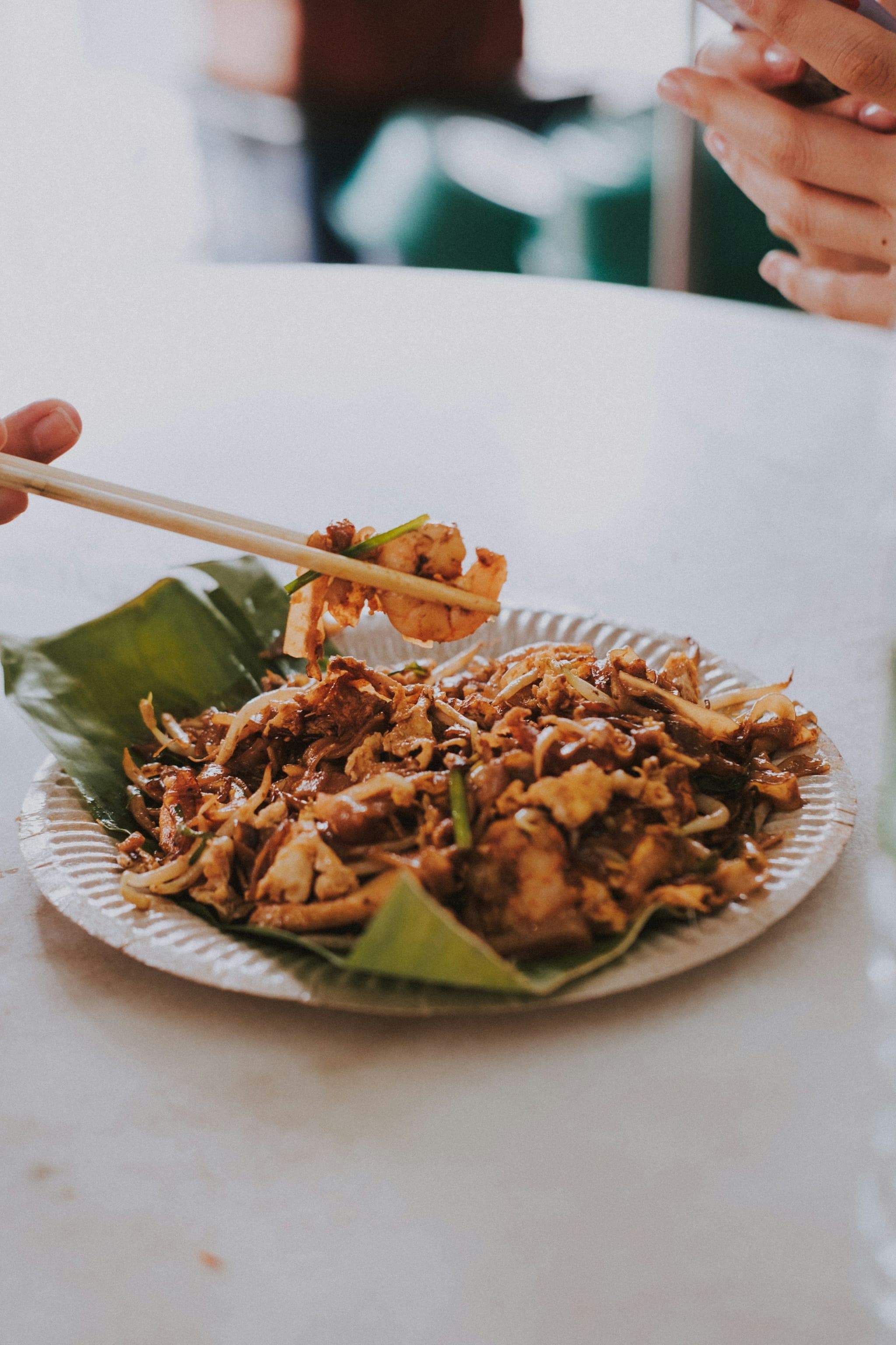 A plate of stir-fried flat rice noodles