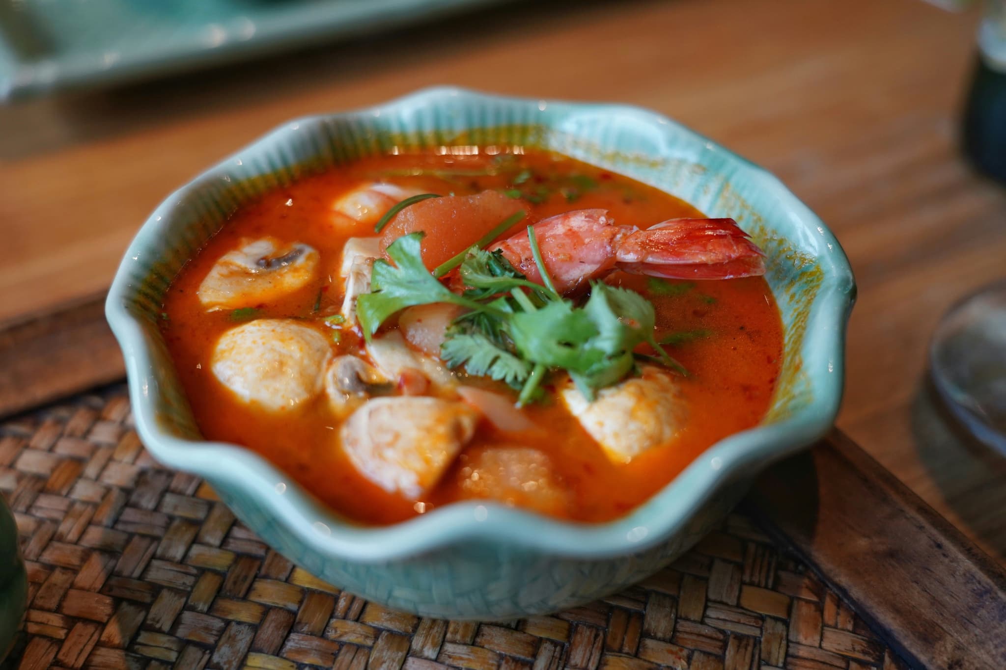 A bowl of Tom Yum Goong soup with shrimp