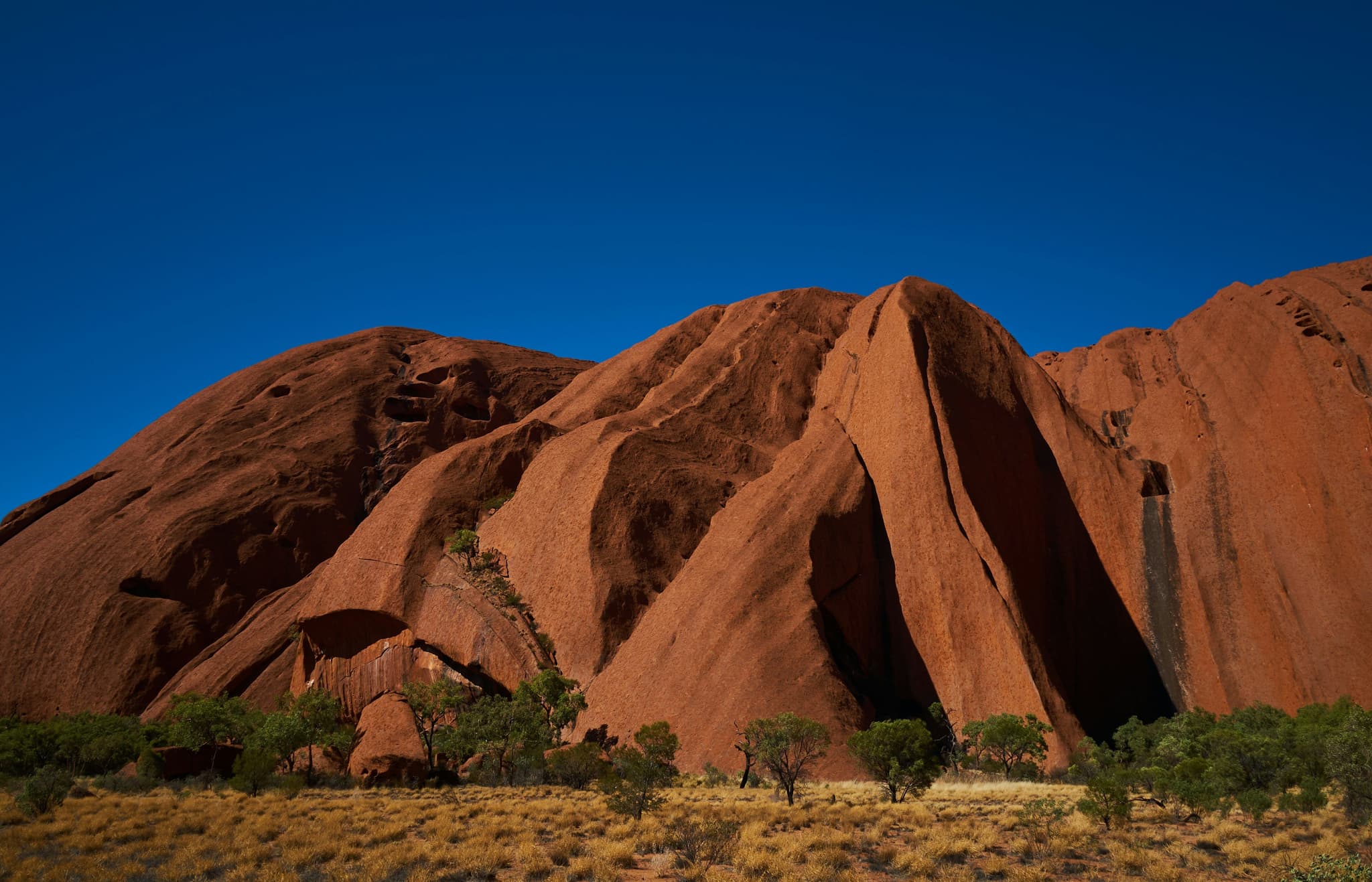 A red coloured rocky mountain in the dry landscape of Uluru and the Red Centre