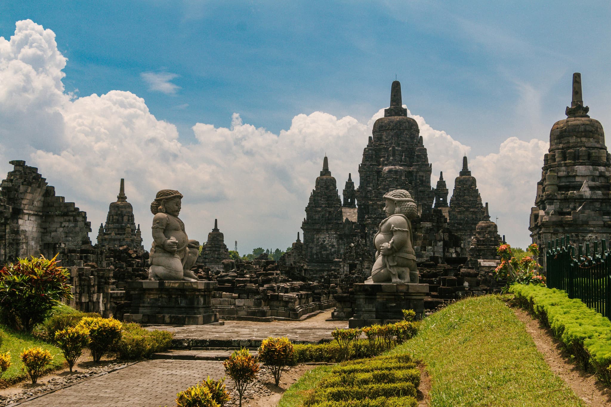 Stone statues in green field in Yogyakarta and Borobudur