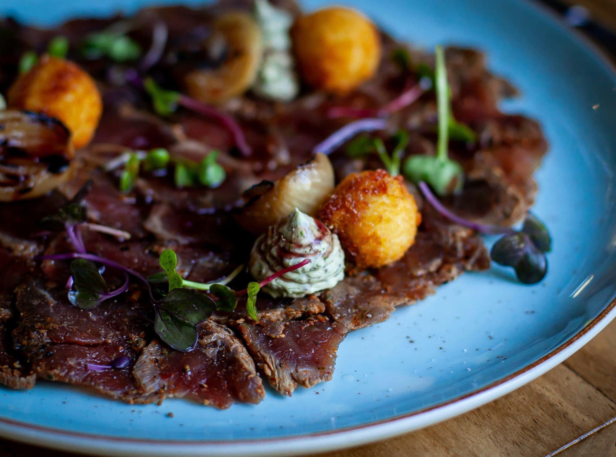Biltong meat on a blue plate