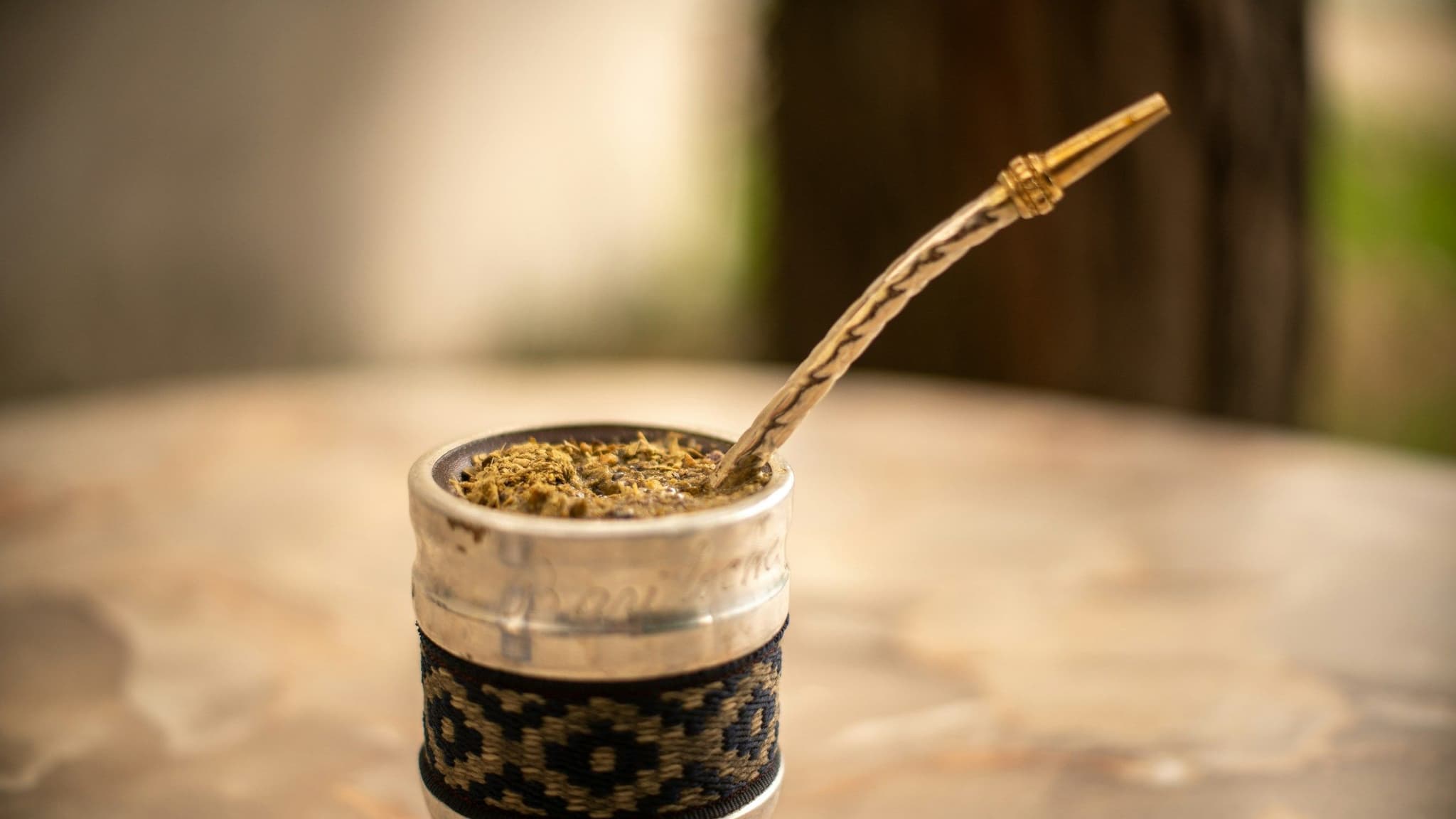 A traditional mate gourd filled with yerba mate and a metal bombilla