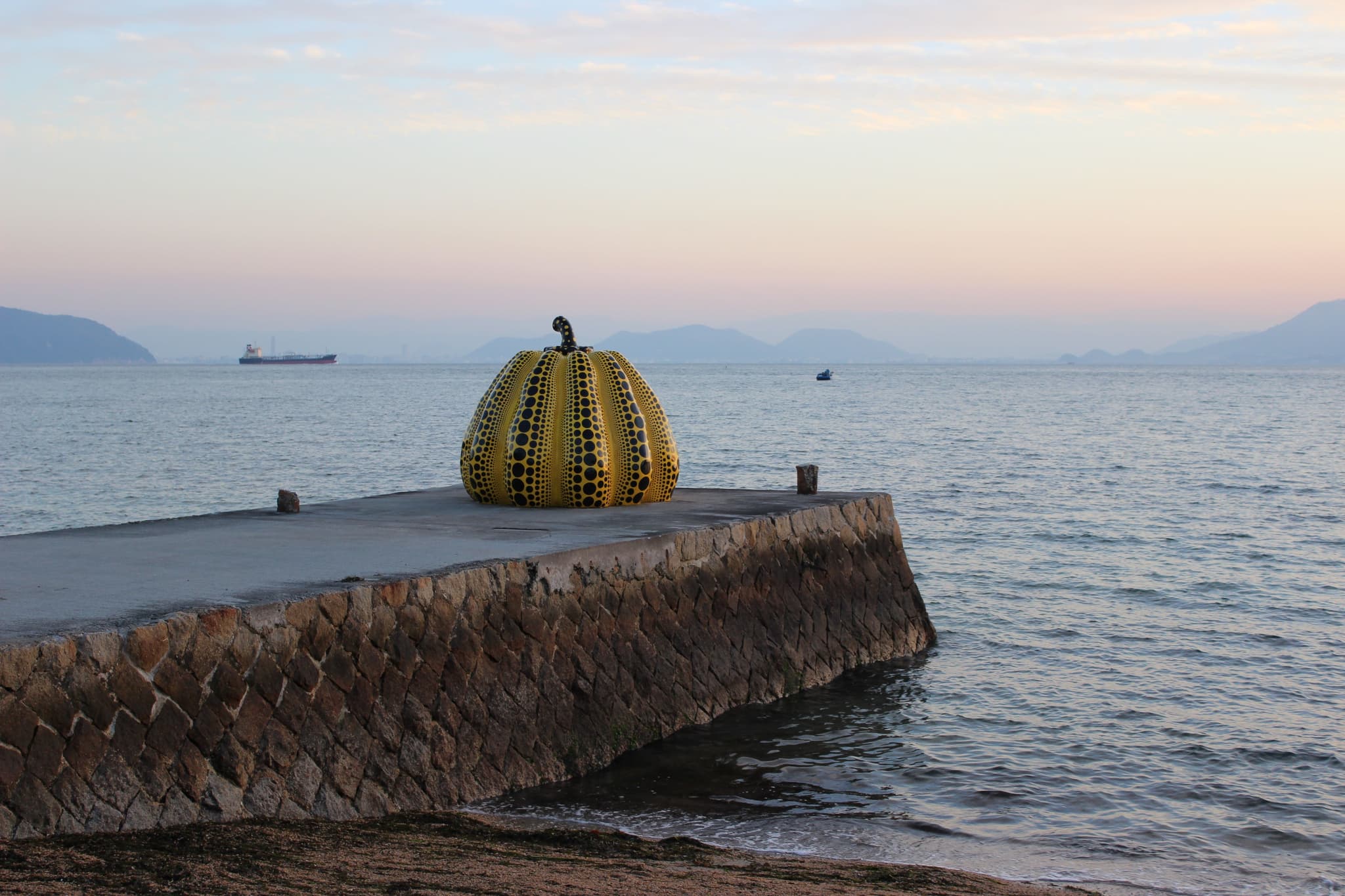 The yellow pumpkin art statue in Naoshima beach