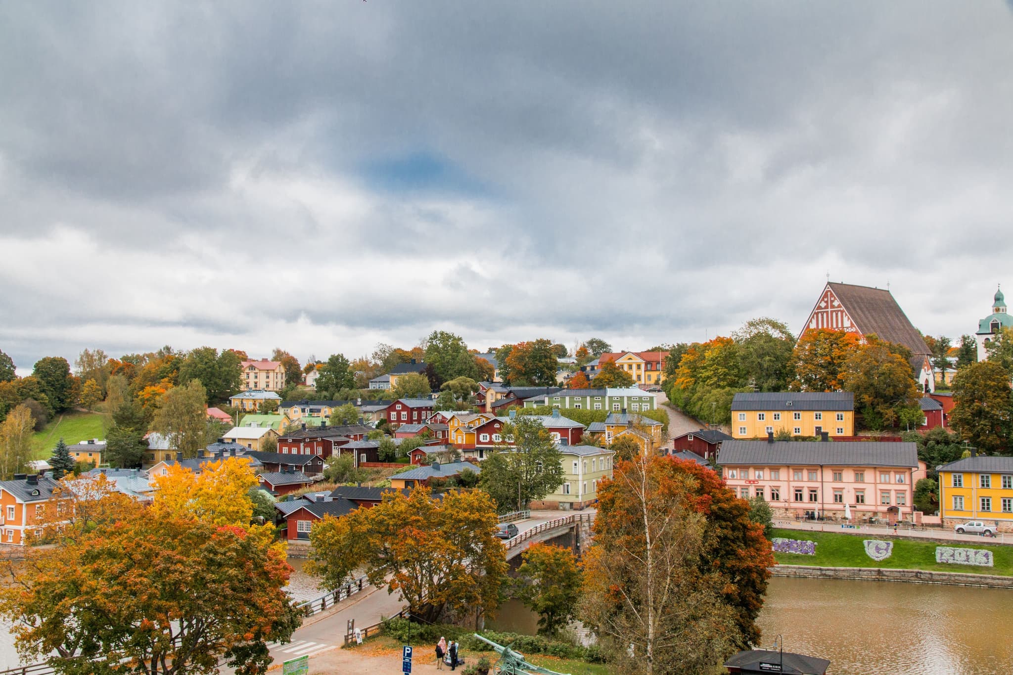 city of porvoo in Finland from above, trees, houses and the river on a cloudy day