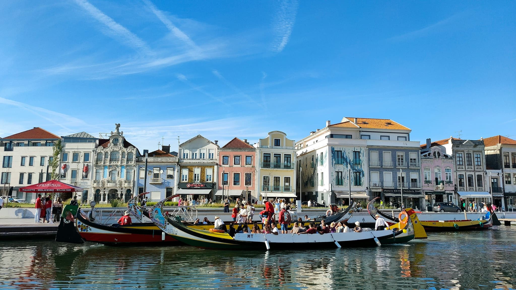 Colourful canal houses and a moliceiro boat in Aveiro, Portugal