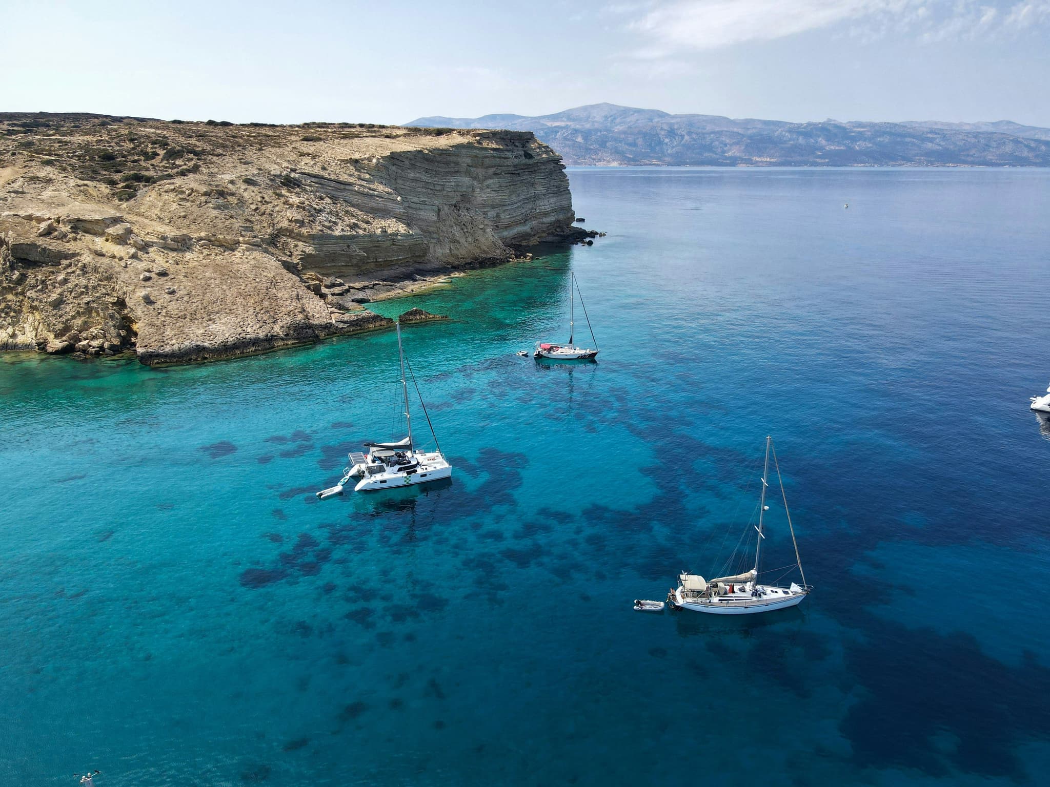 Aerial view of sailing boats in turqoise water in Koufonisia