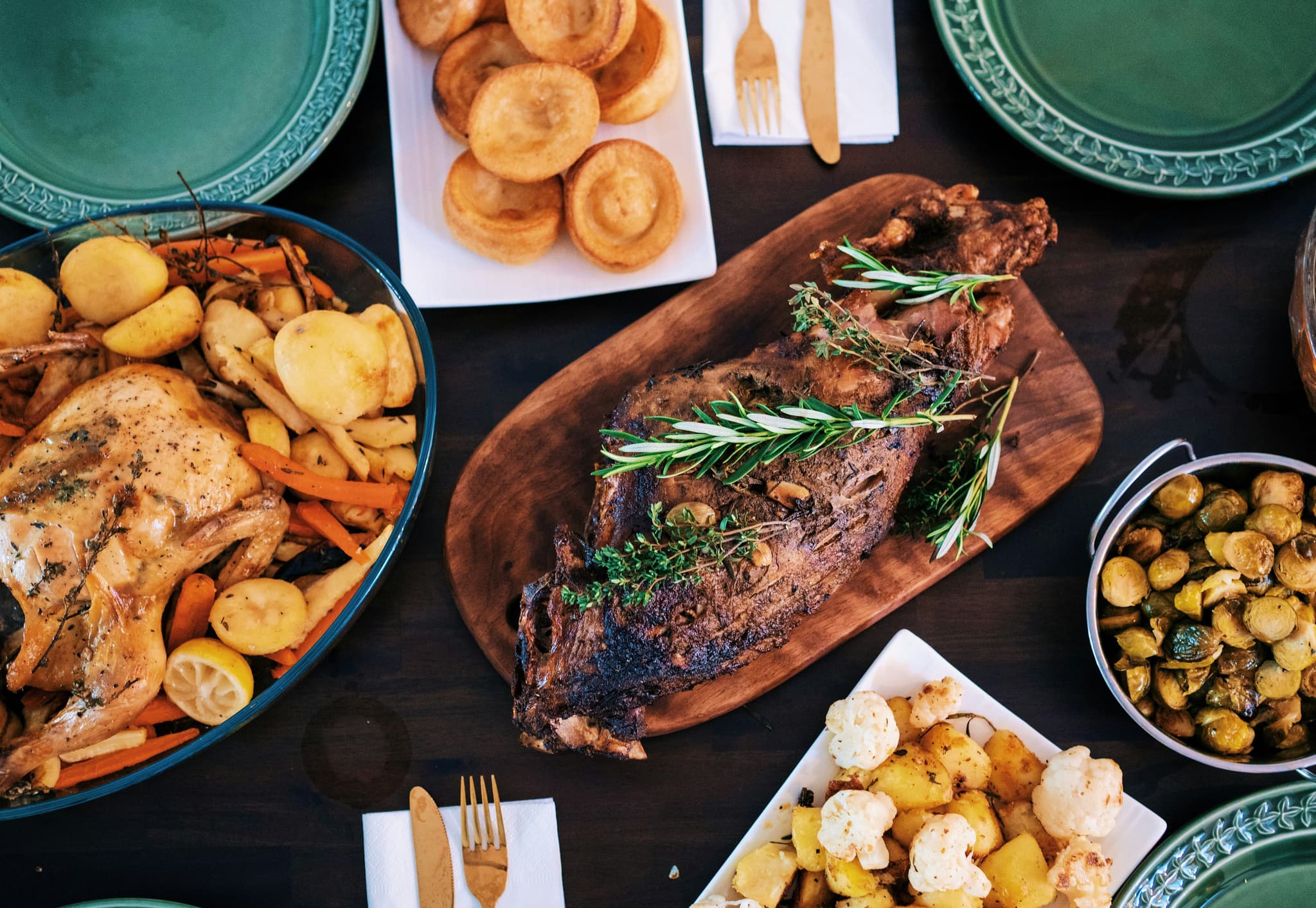 Icelandic lamb on a wooden cutting board on a table with plates with potatoes