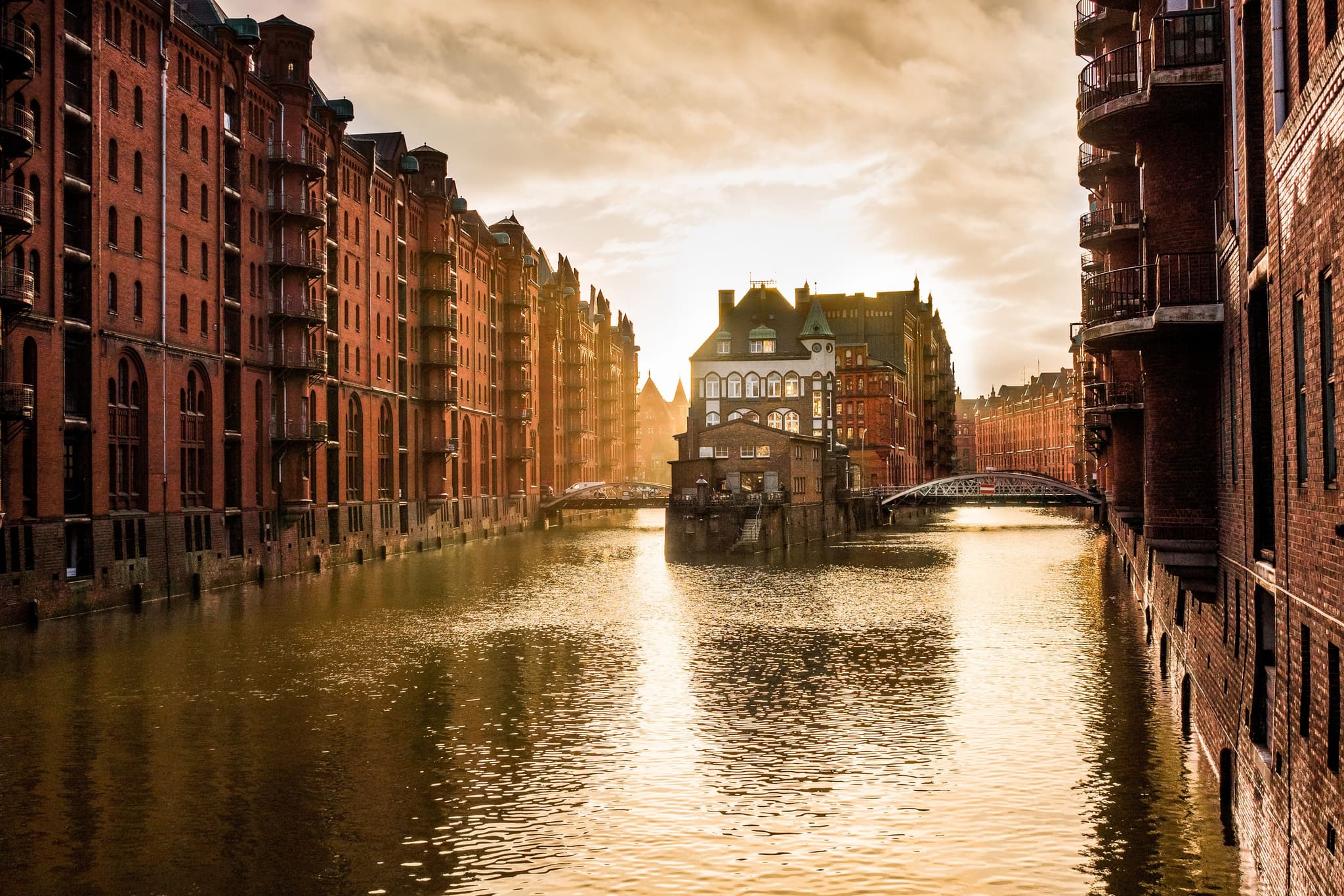 Red brick warehouses of Hamburg's historic Speicherstadt and river at dusk