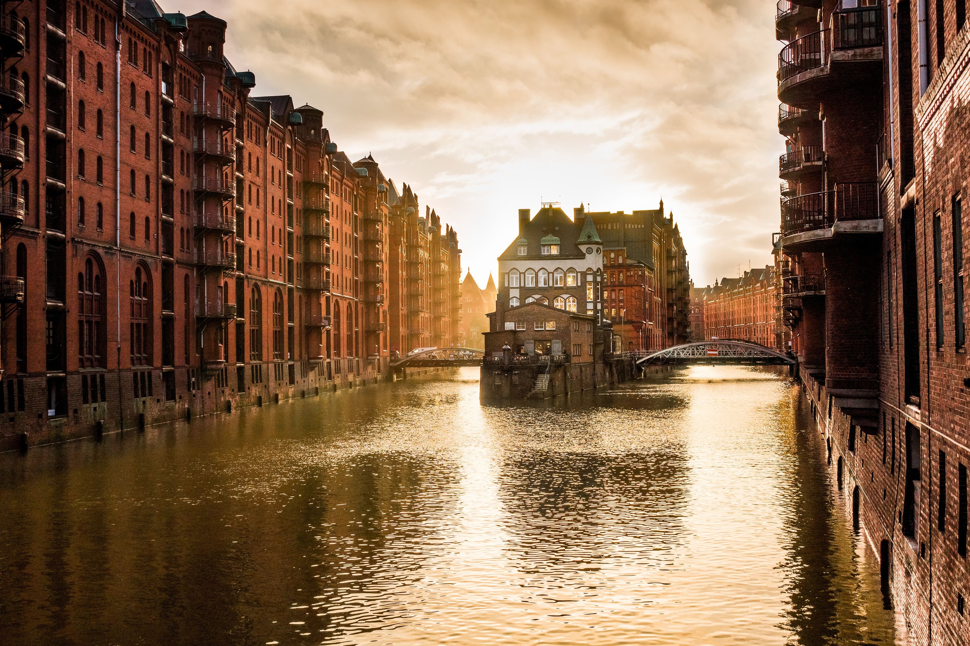 Red brick warehouses of Hamburg's historic Speicherstadt and river at dusk