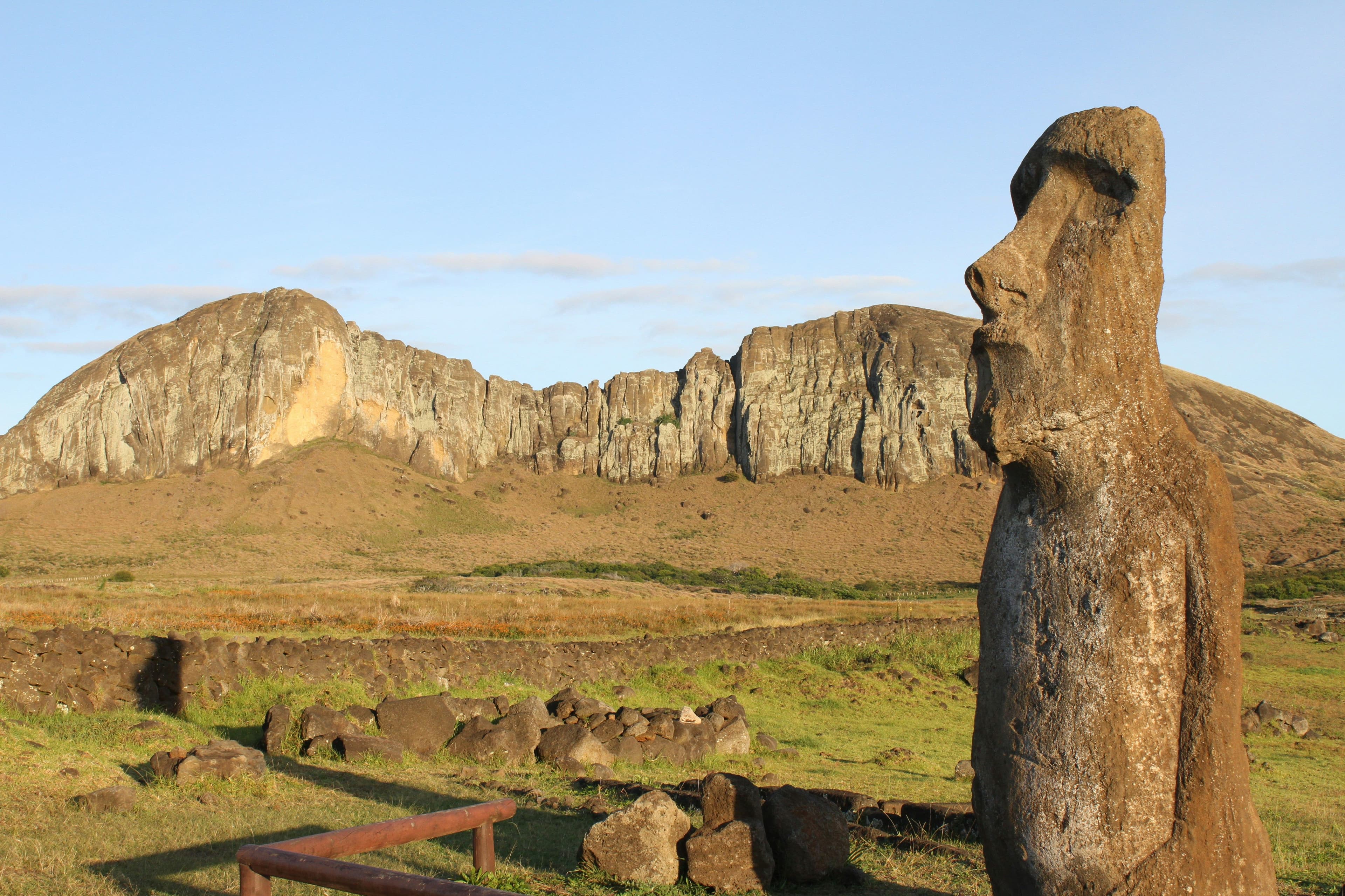 A face stone sculpture in green hills in Easter Island