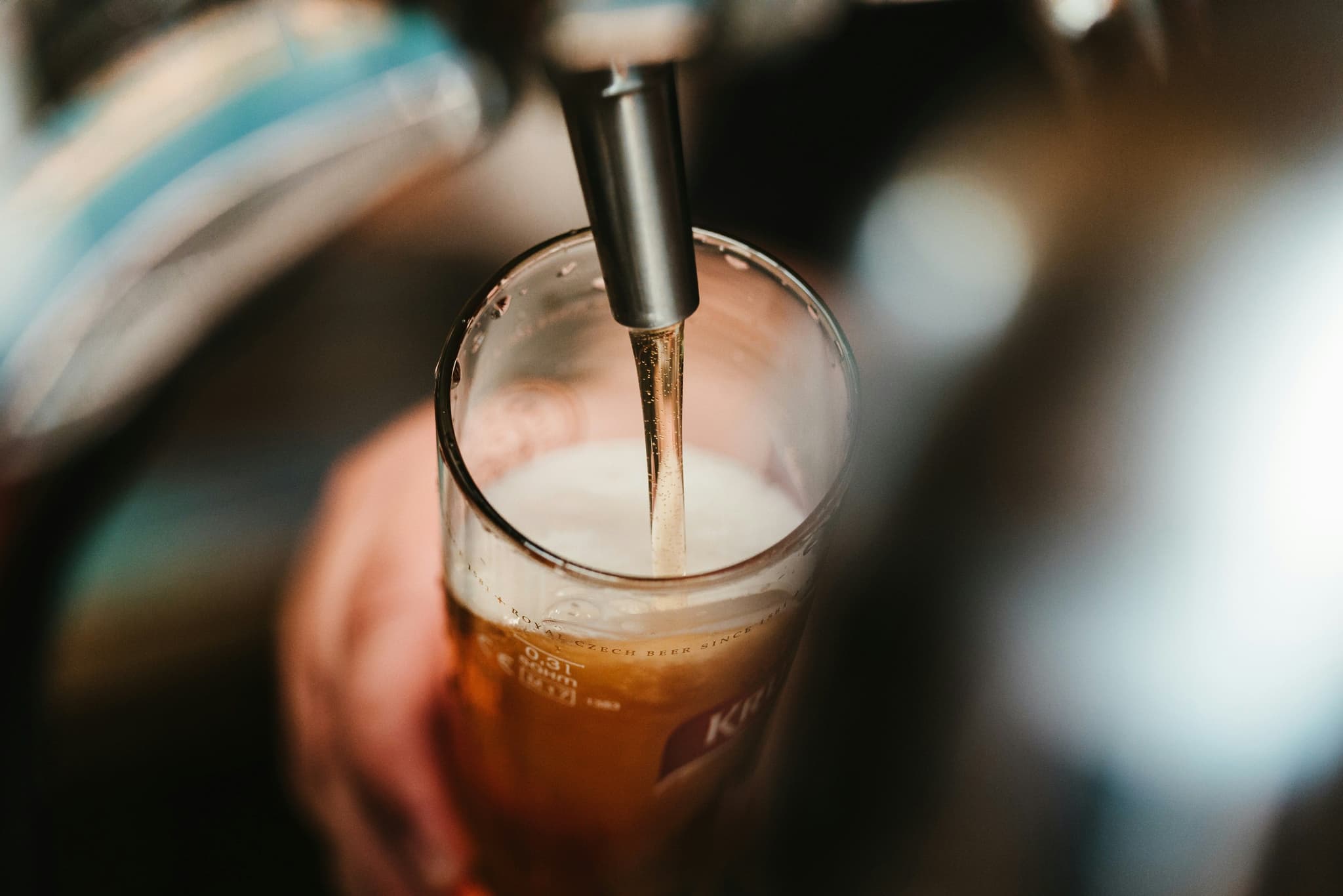 Beer tap pouring beer into glass