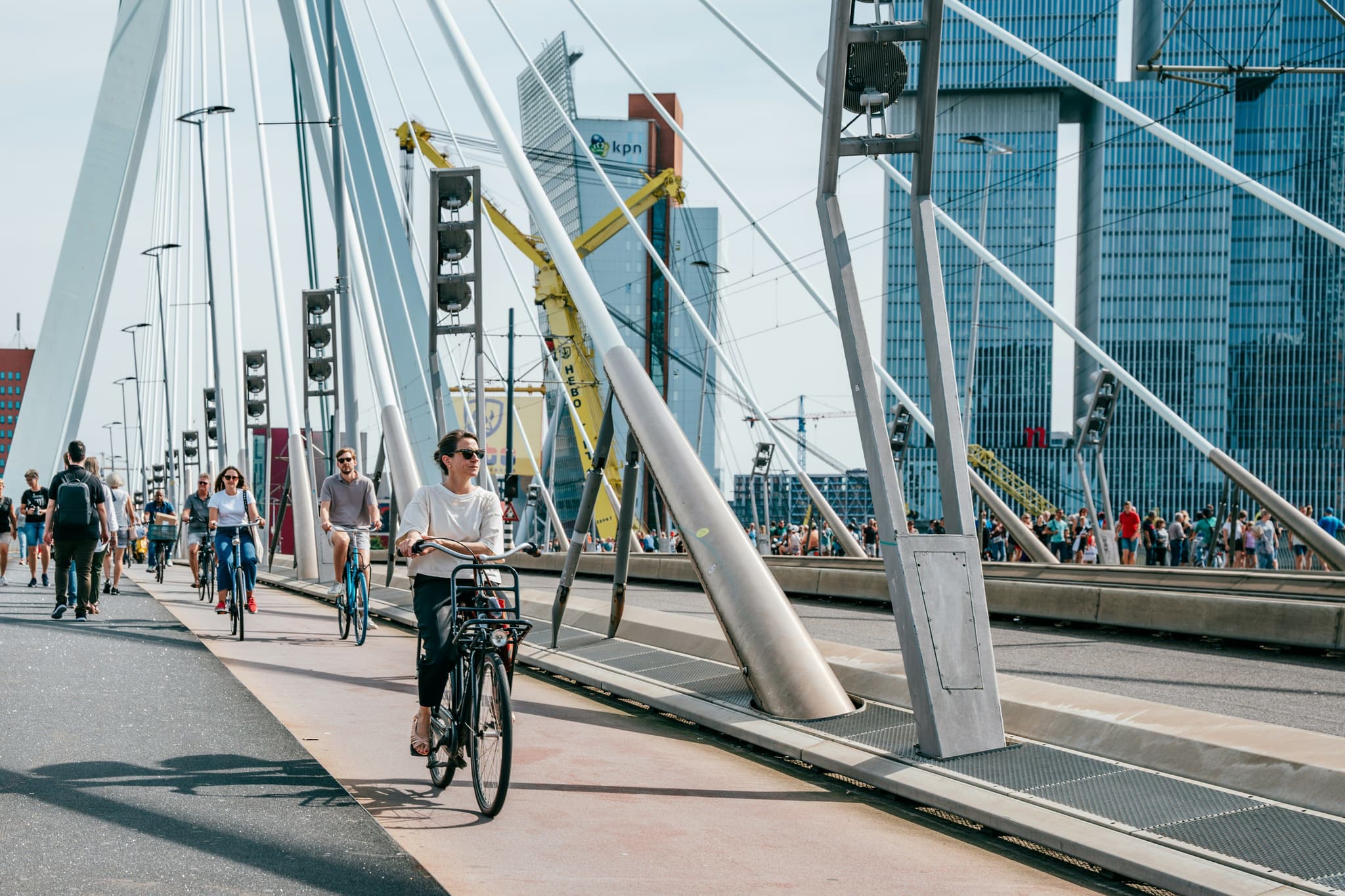 A woman cycling on the Rotterdam bridge