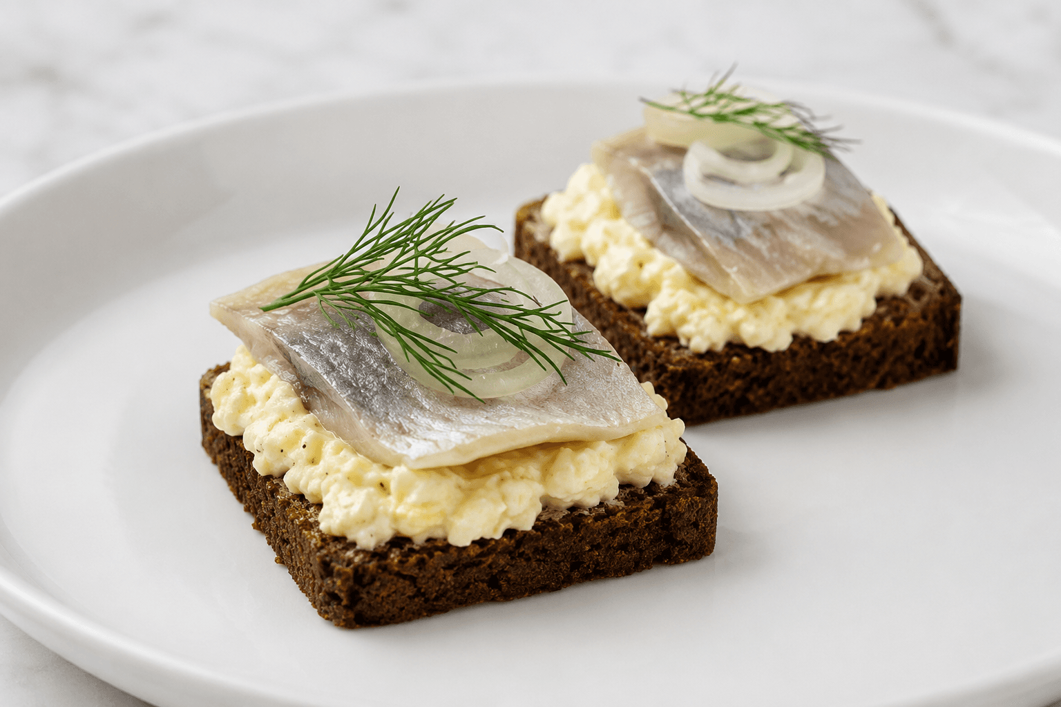 pickled herring on a toast on a plate