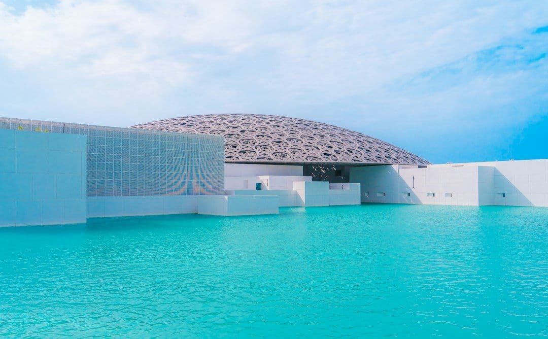 The Louvre Abu Dhabi's dome structure beside the water on Saadiyat Island