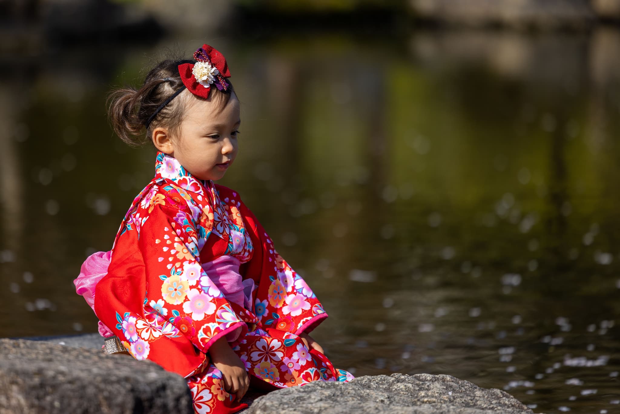 Child dressed in traditional kimono during a Shichi Go San celebration outside a Japanese shrine