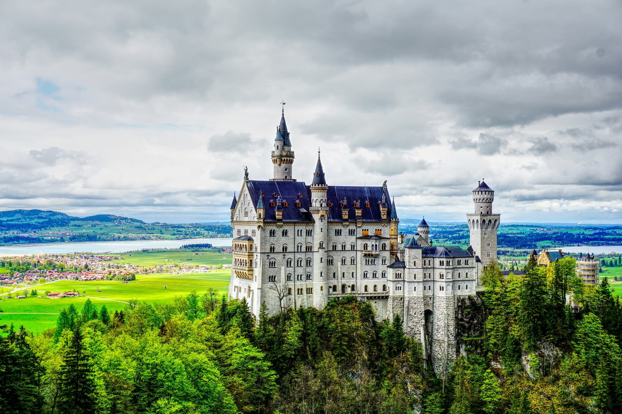 Neuschwanstein Castle surrounded by mountains in Bavaria, Germany